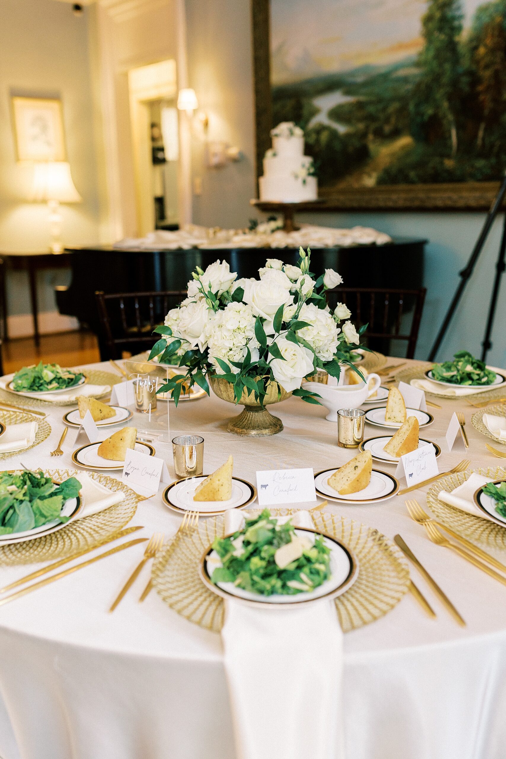 wedding reception with salads and gold place settings 