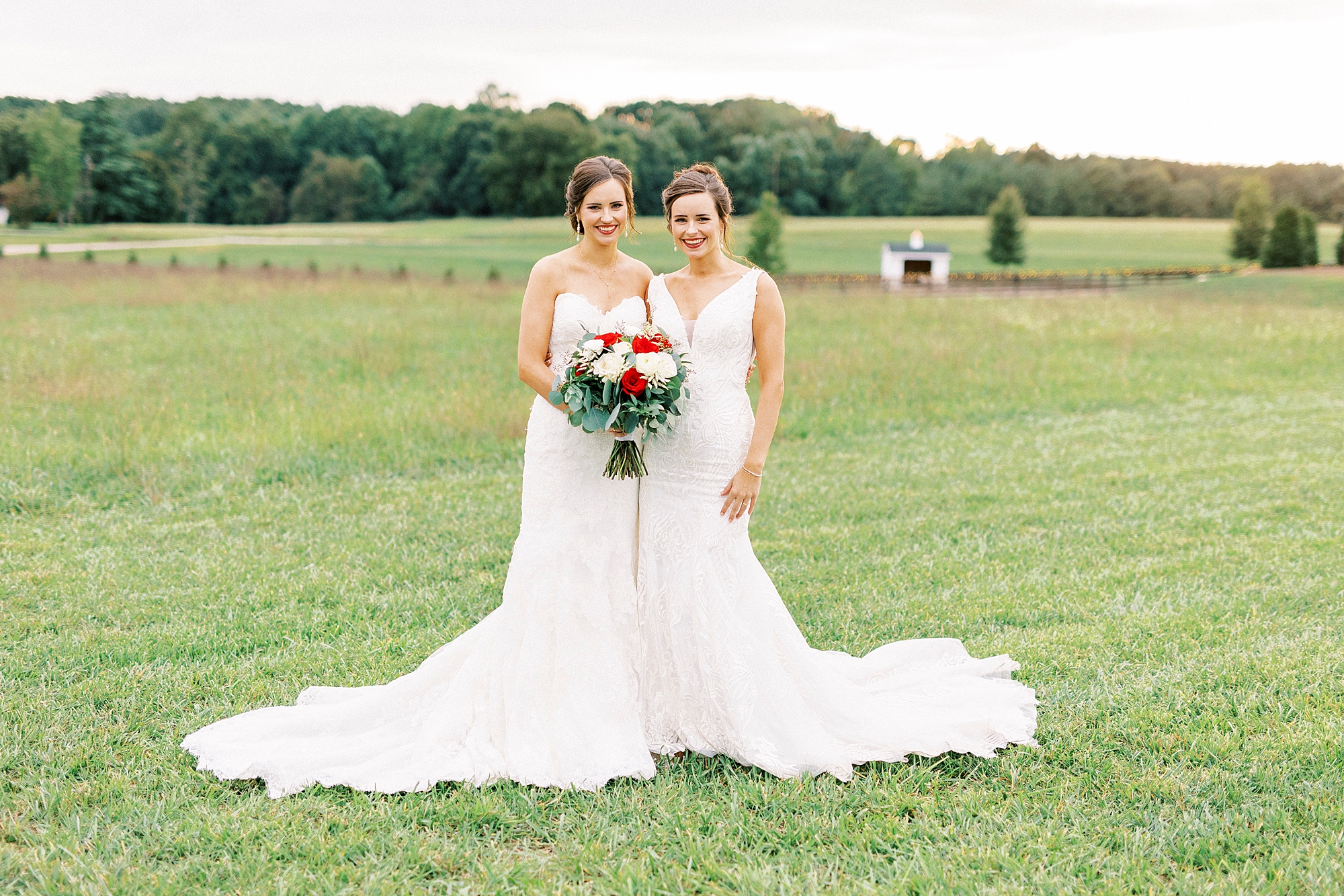 bride hugs sister in wedding gowns during Chickadee Hill Farms bridal portraits 