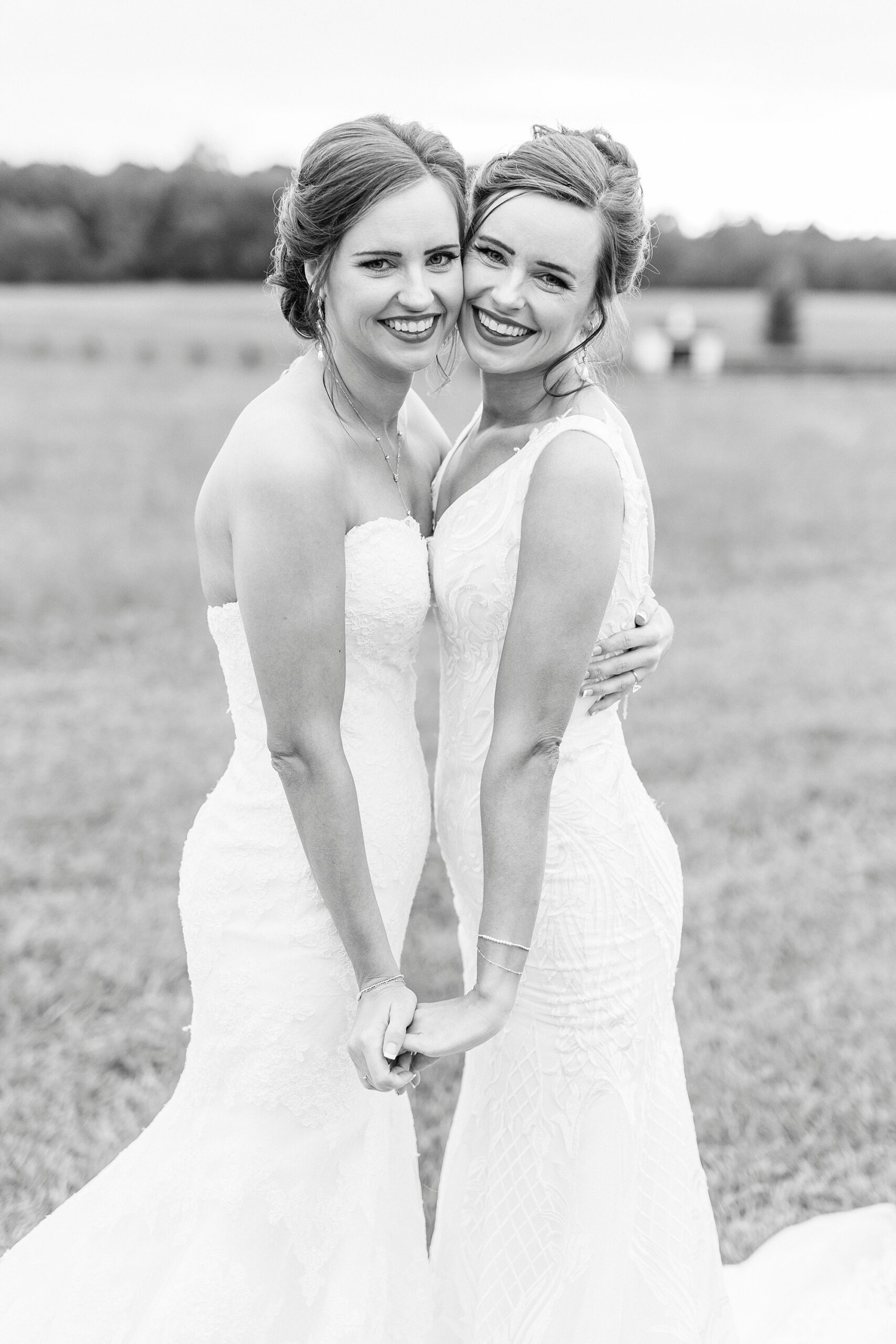bride hugs sister in wedding dress during portraits at Chickadee Hill Farms