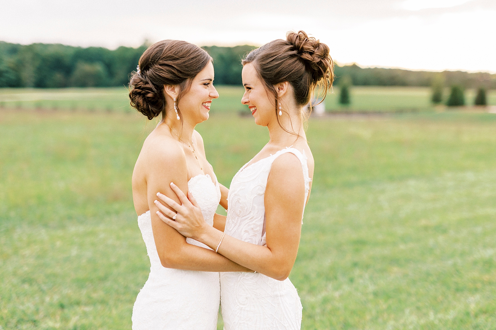 two sisters hug facing each other during Chickadee Hill Farms bridal portraits 