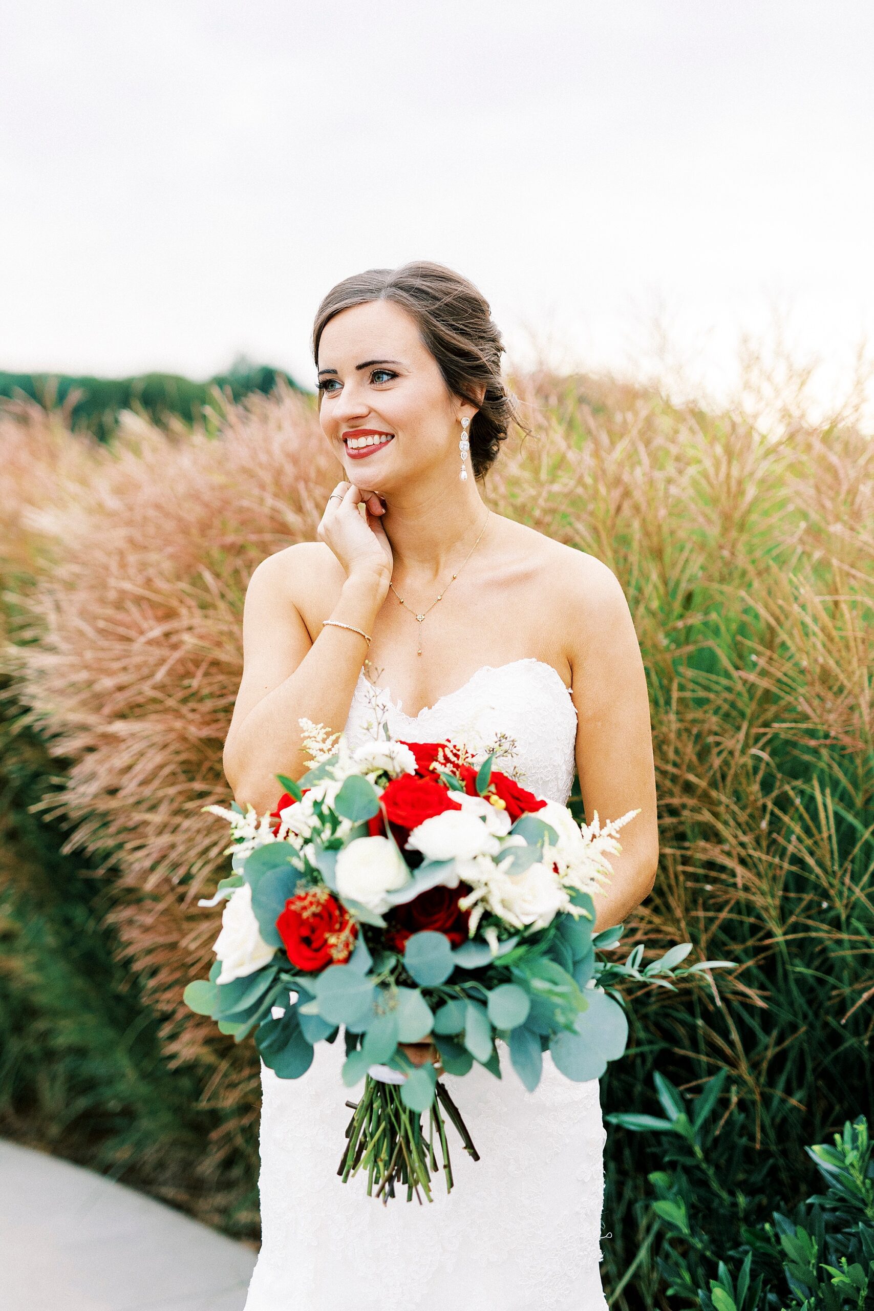 bride holds chin during Chickadee Hill Farms bridal portraits 