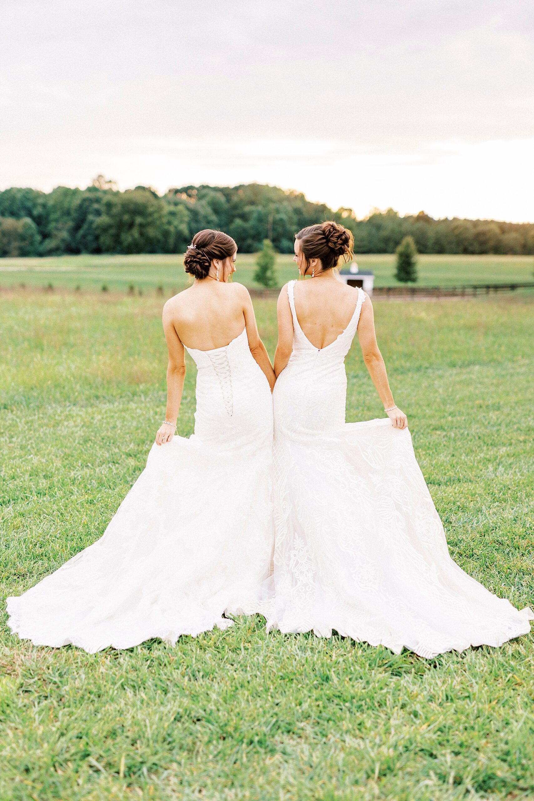 bride and sister bump hips during Chickadee Hill Farms bridal portraits 