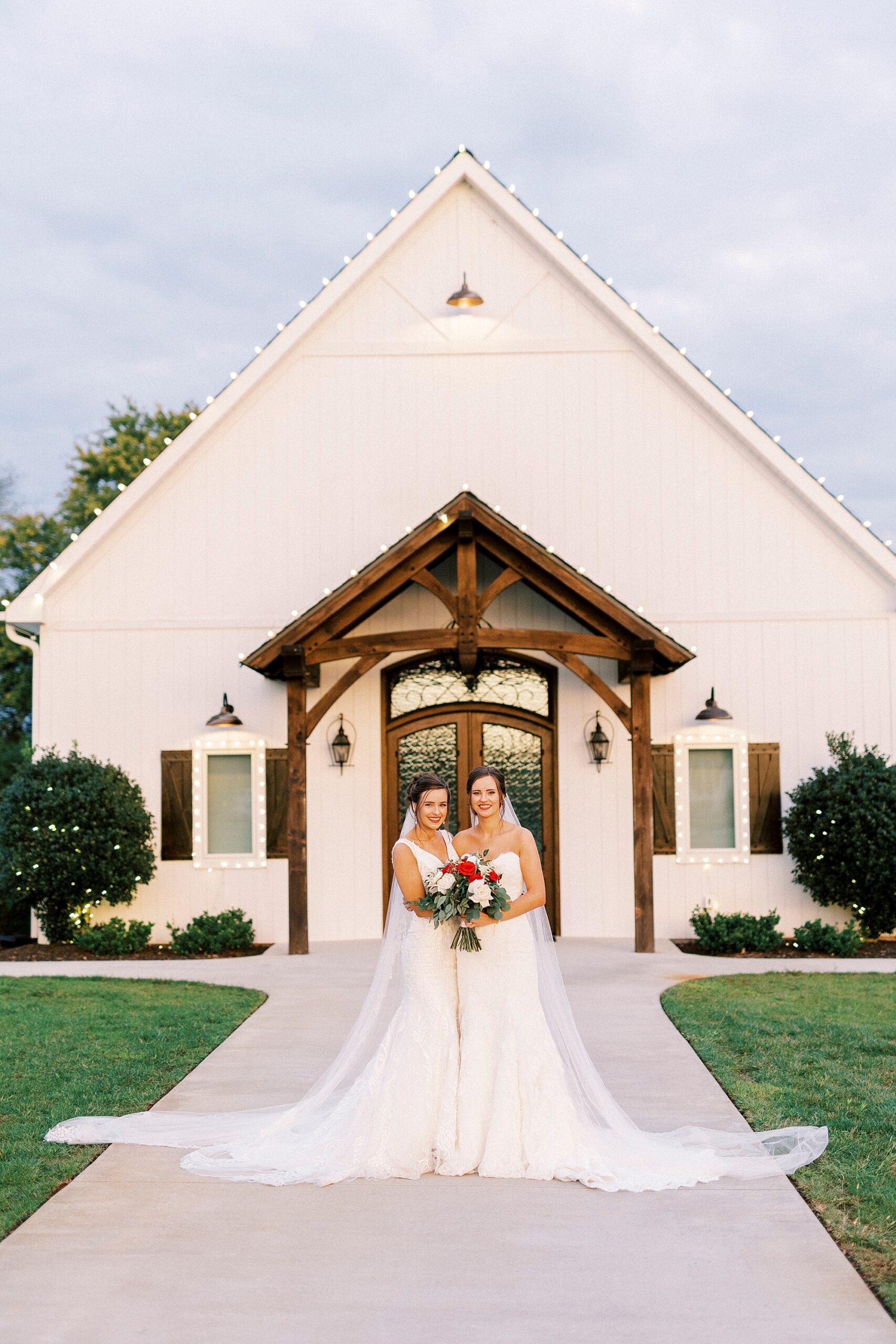 bride and sister face each other in front of chapel at Chickadee Hill Farms