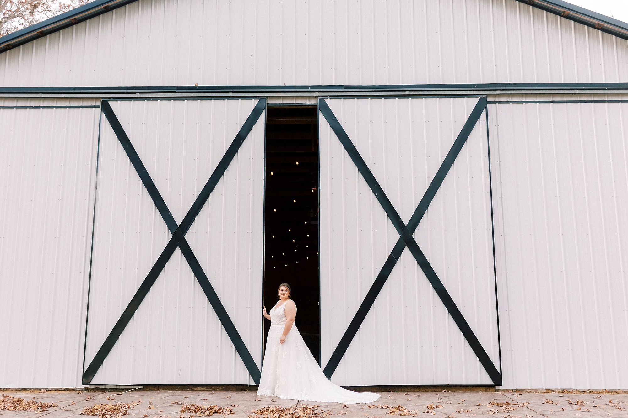 bride stands between barn doors during the Farm at Brusharbor bridal portraits 