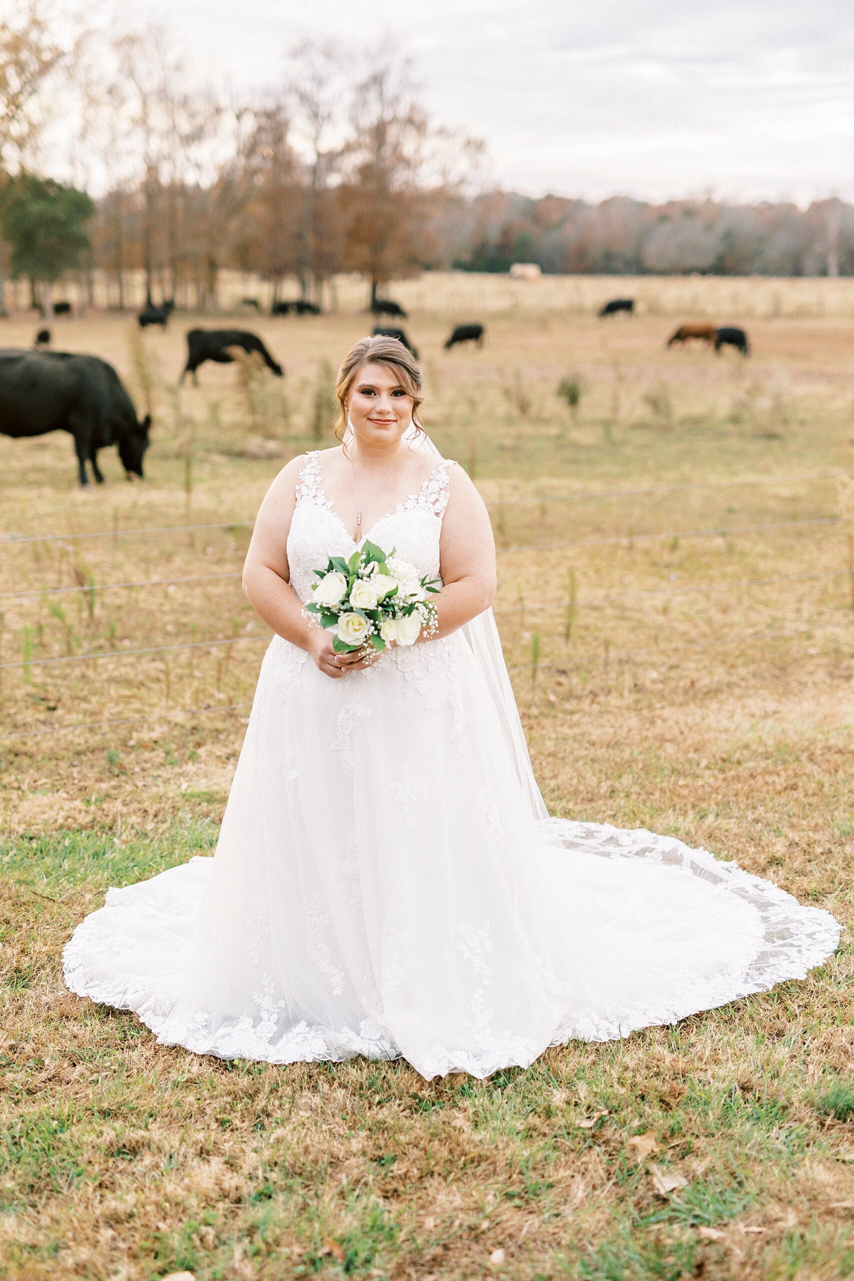 bride stands in field during fall bridal portraits at the Farm at Brusharbor