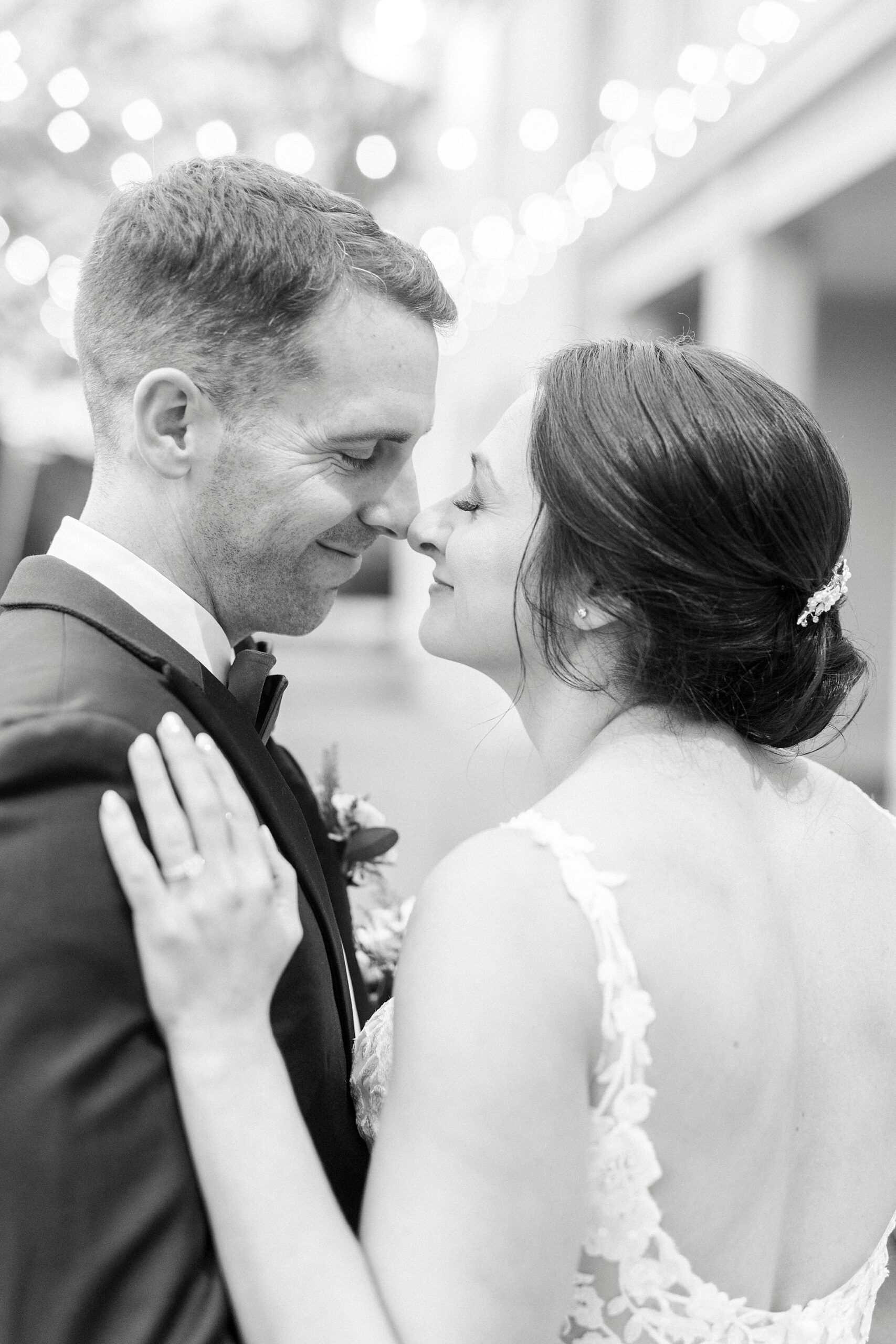 bride and groom lean together touching noses in Charlotte NC