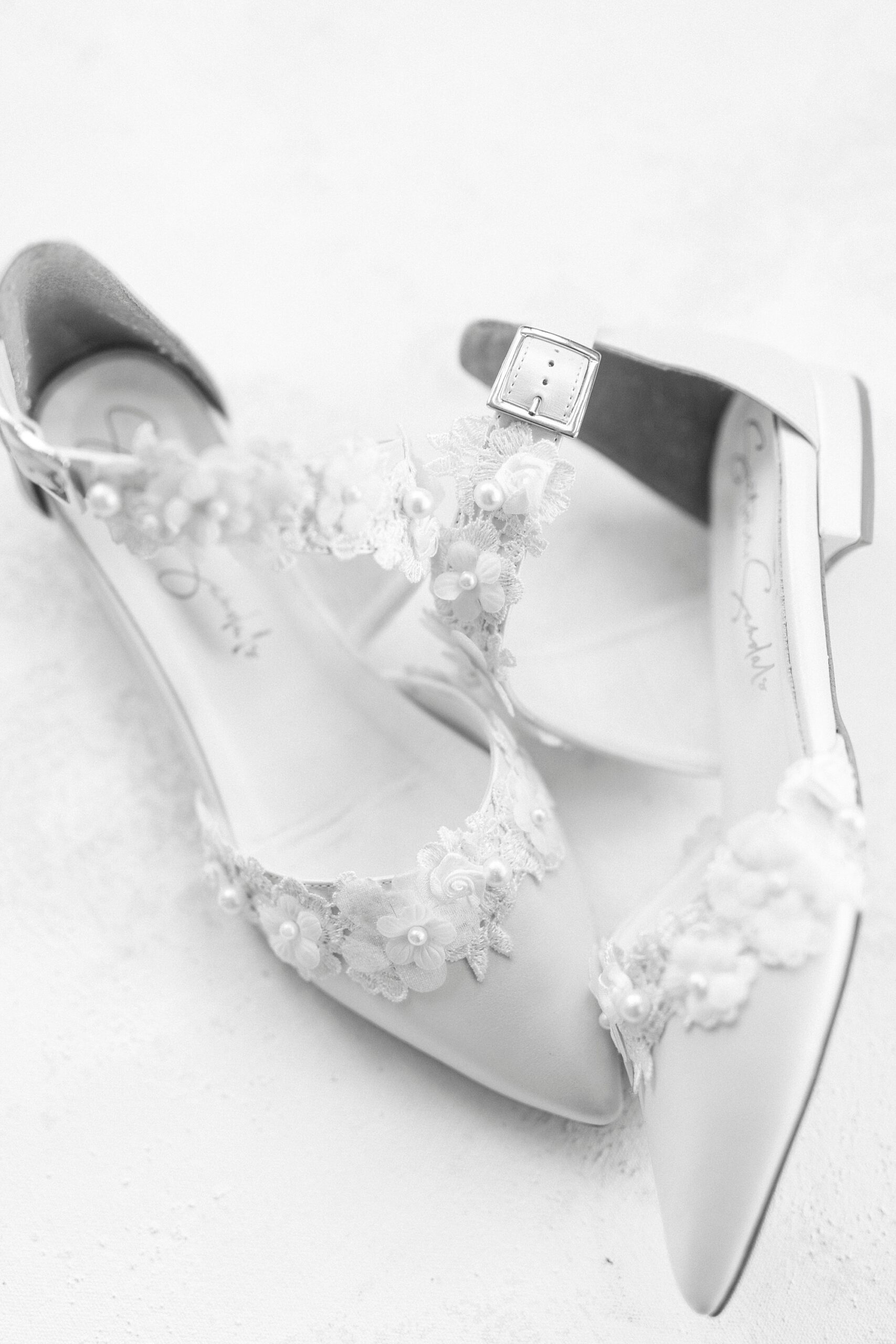 bride's heels with lace detailing across top and strap