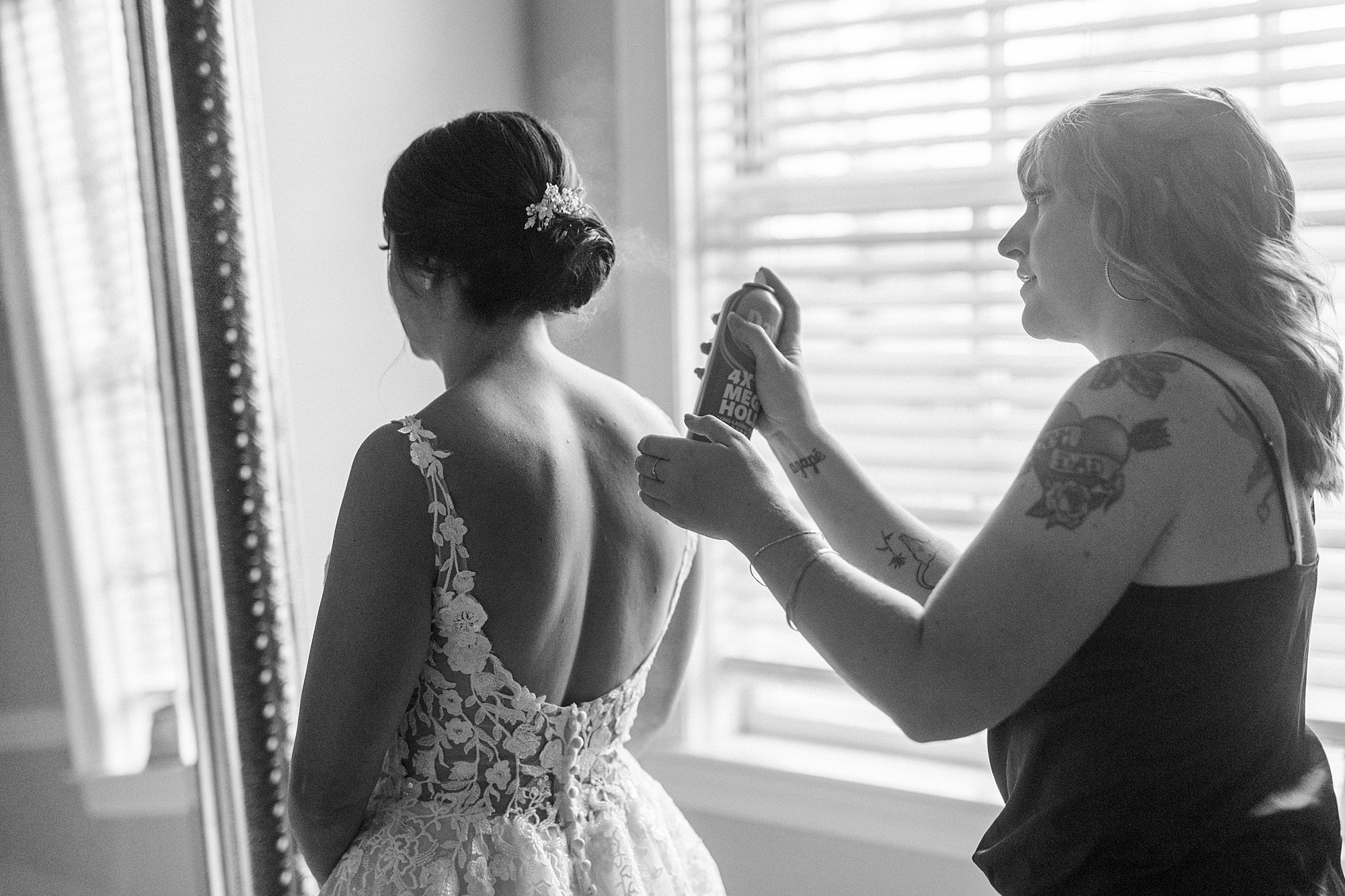 mother sprays bride's hair during wedding prep at Separk Mansion