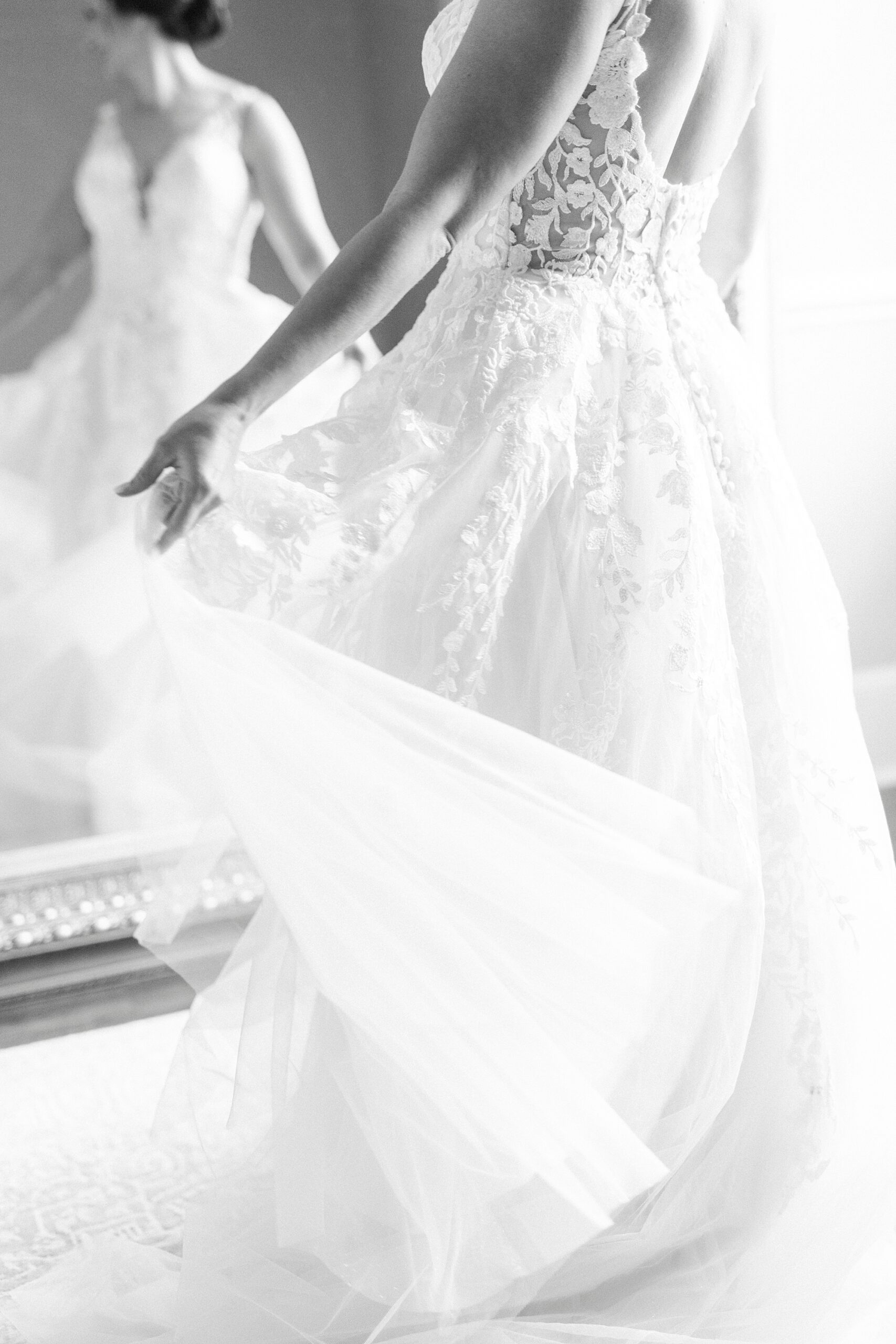 bride twirls wedding dress in mirror in suite at the Separk Mansion