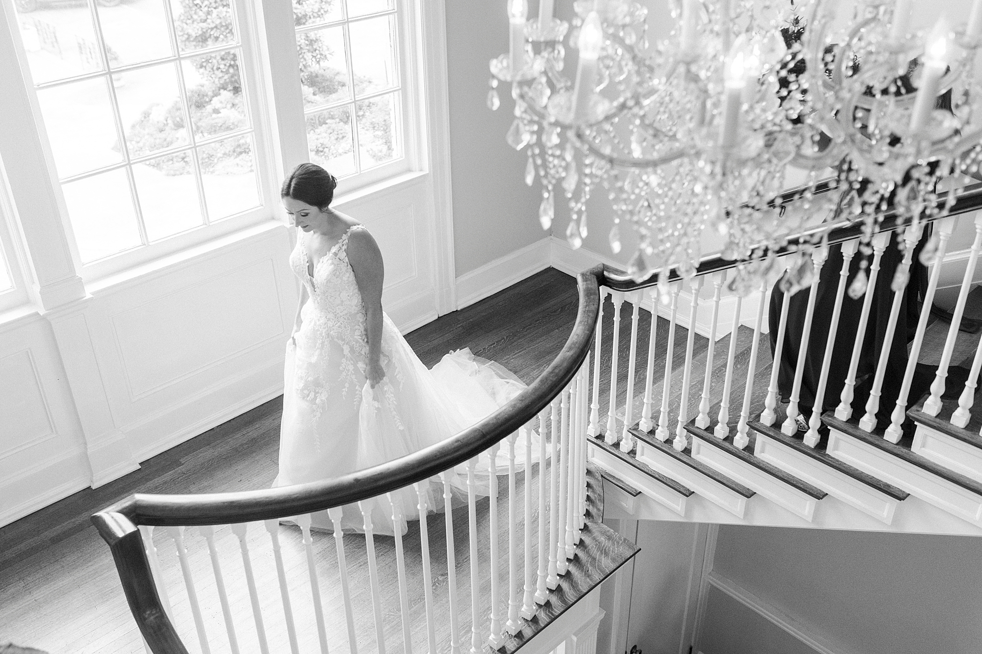bride walks on staircase near chandelier inside the Separk Mansion
