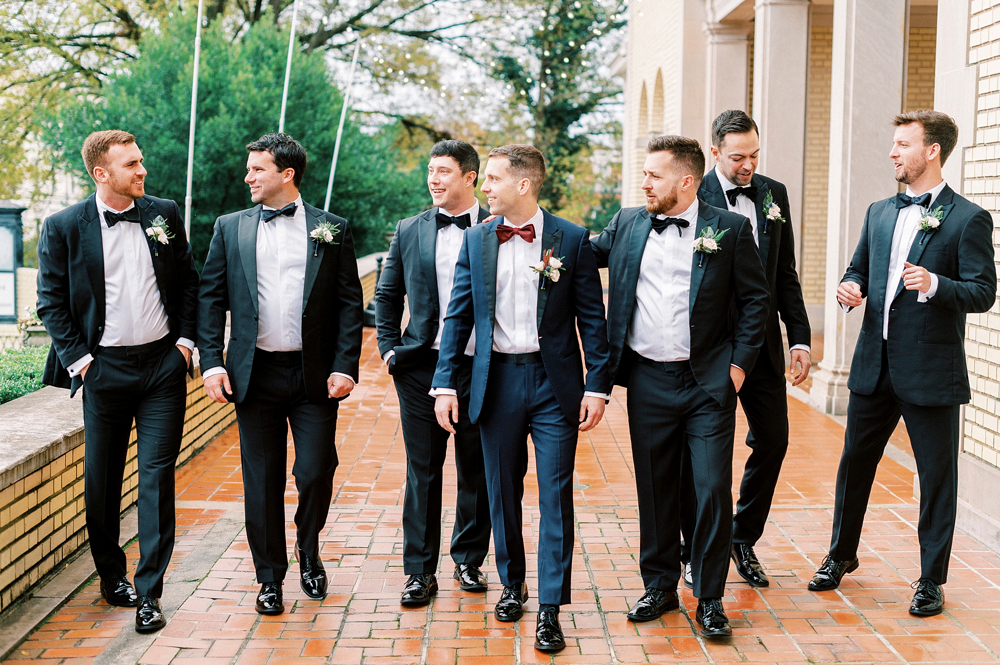 groom walks with groomsmen outside Separk Mansion