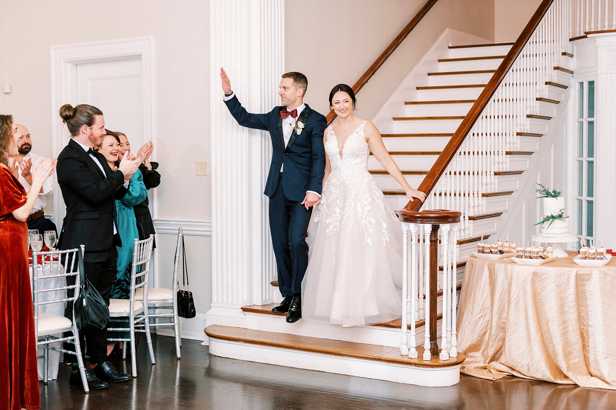 bride and groom stand on bottom of staircase inside Separk Mansion