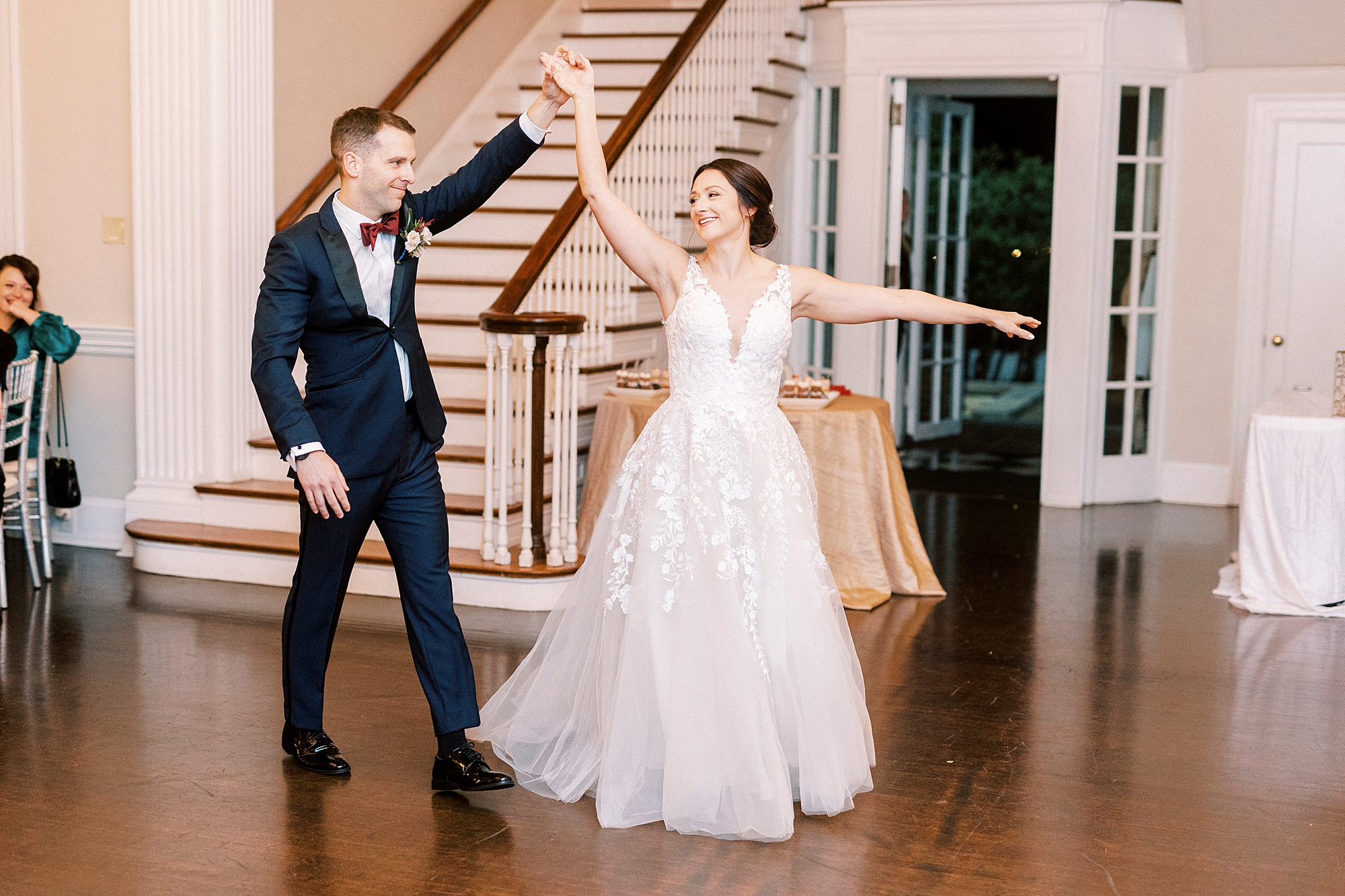 groom twirls bride during NC wedding reception dances 