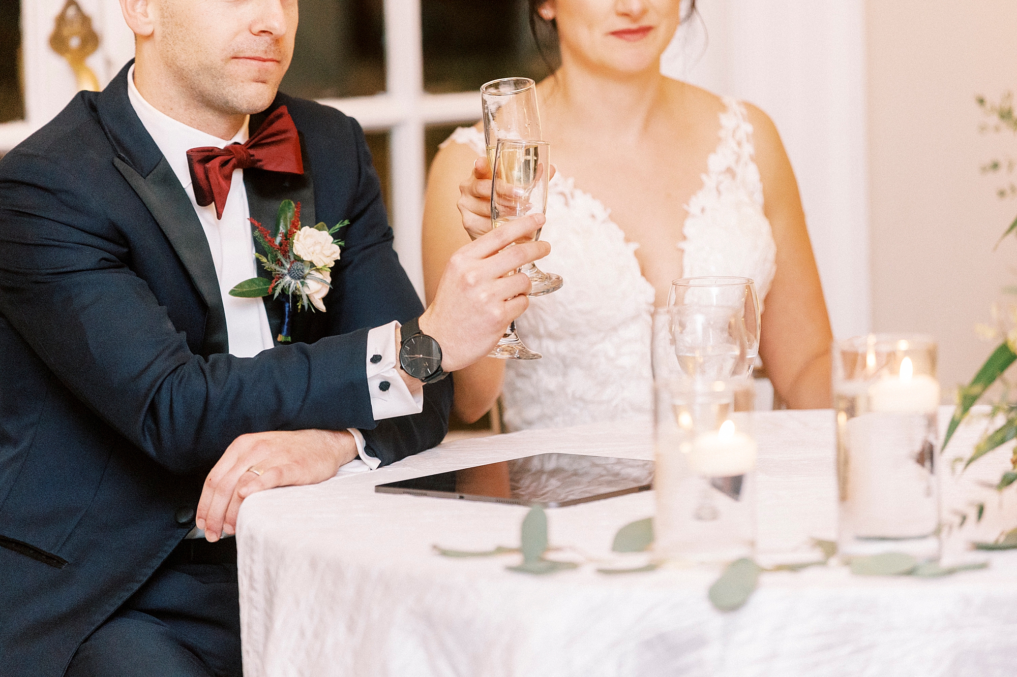 newlyweds listen to toasts and clink champagne glasses 