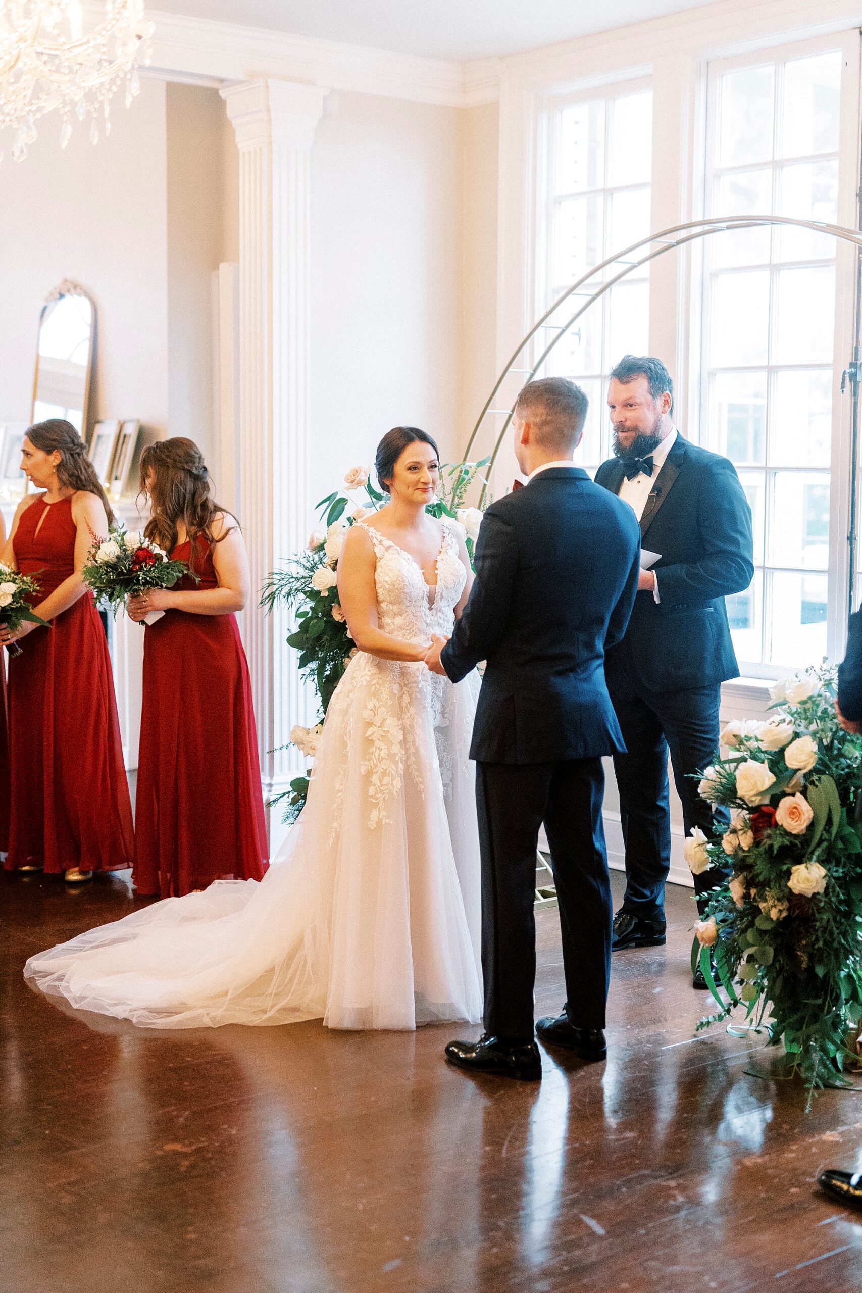 newlyweds hold hands exchanging vows inside Separk Mansion