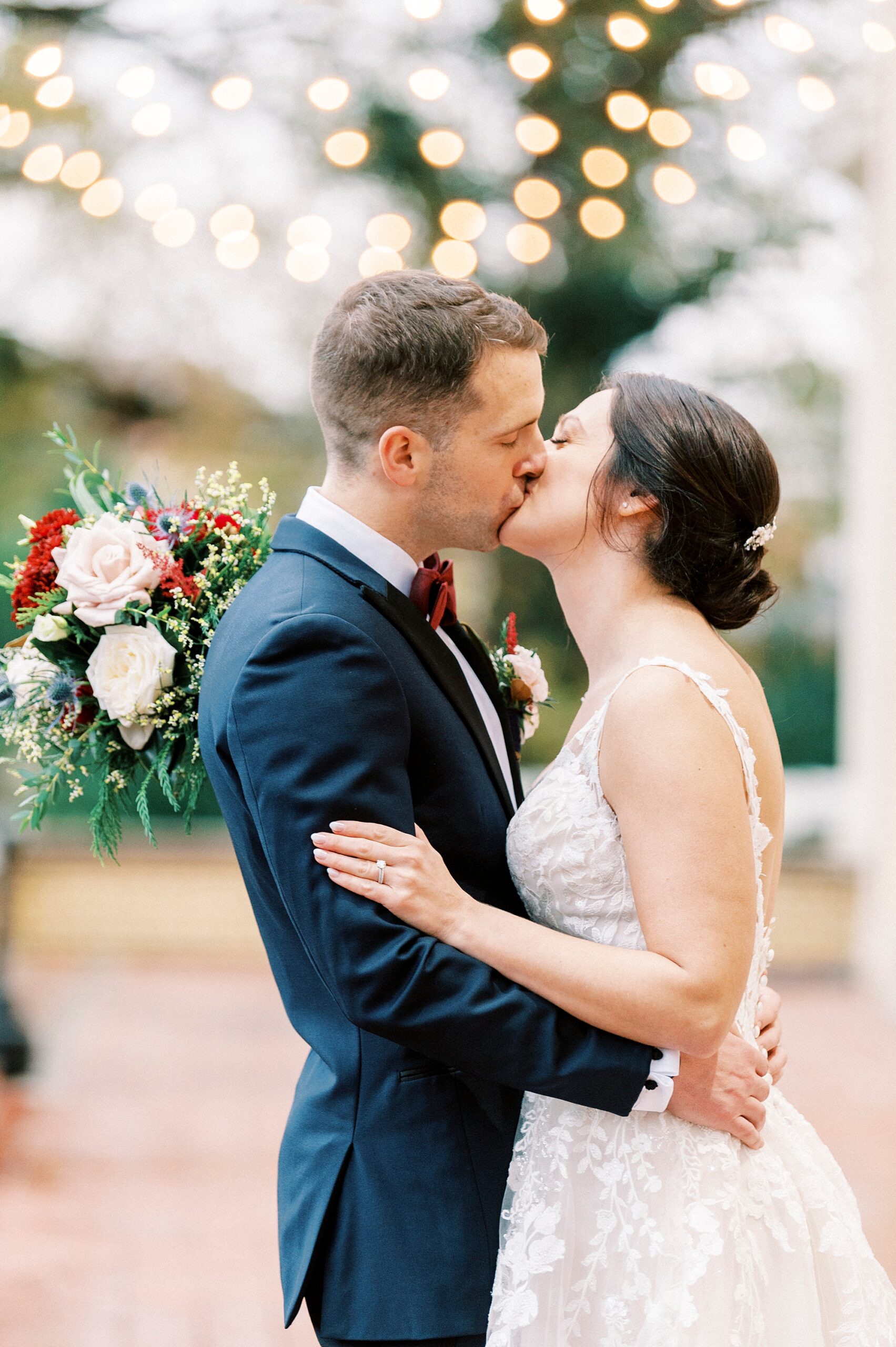 bride and groom kiss during winter wedding portraits outside Separk Mansion