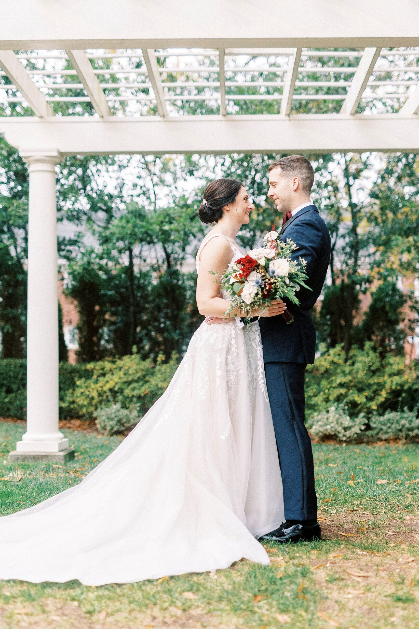 newlyweds stand together under white gazebo at Separk Mansion 