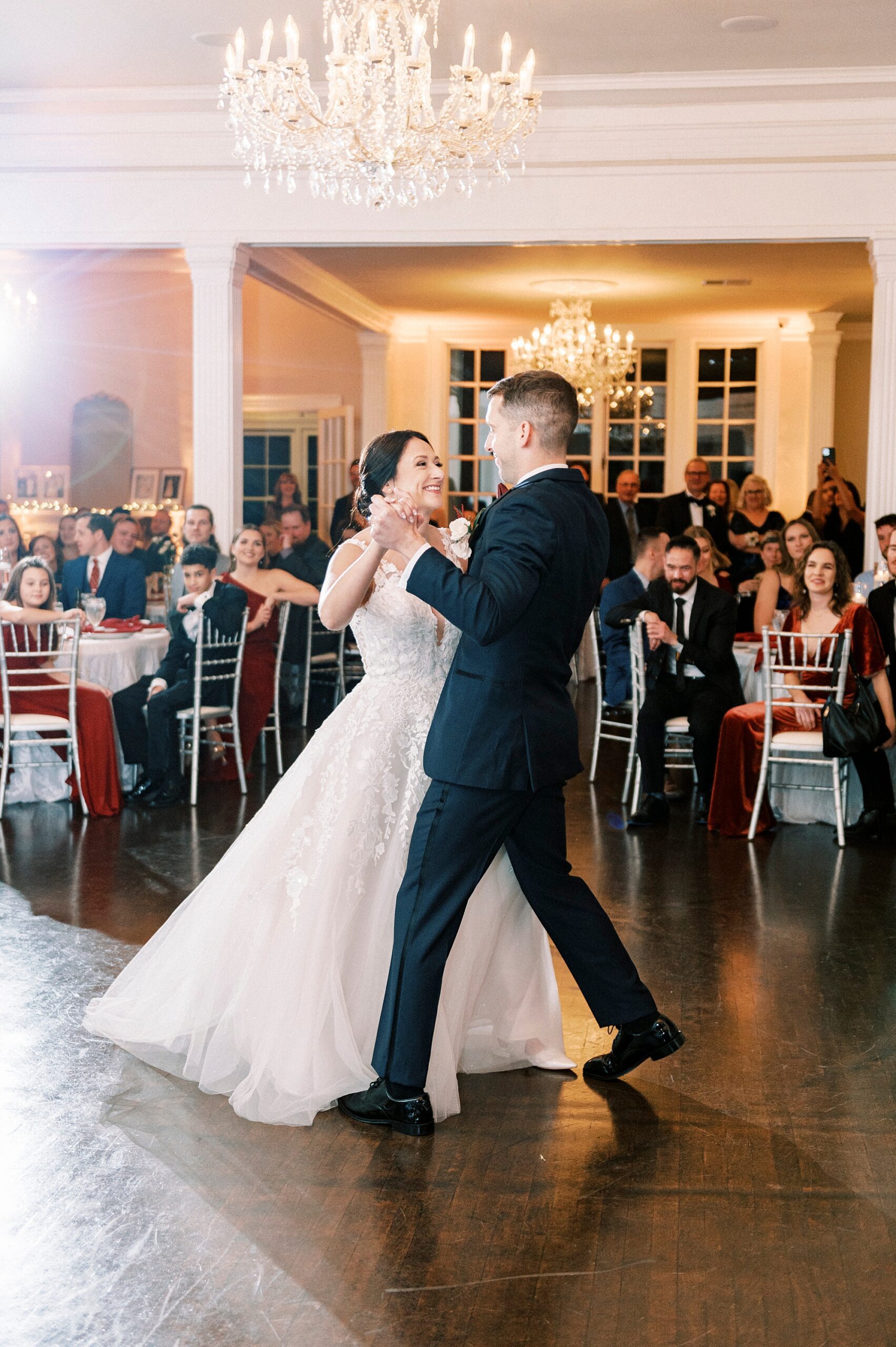 groom twirls bride around during first dance 