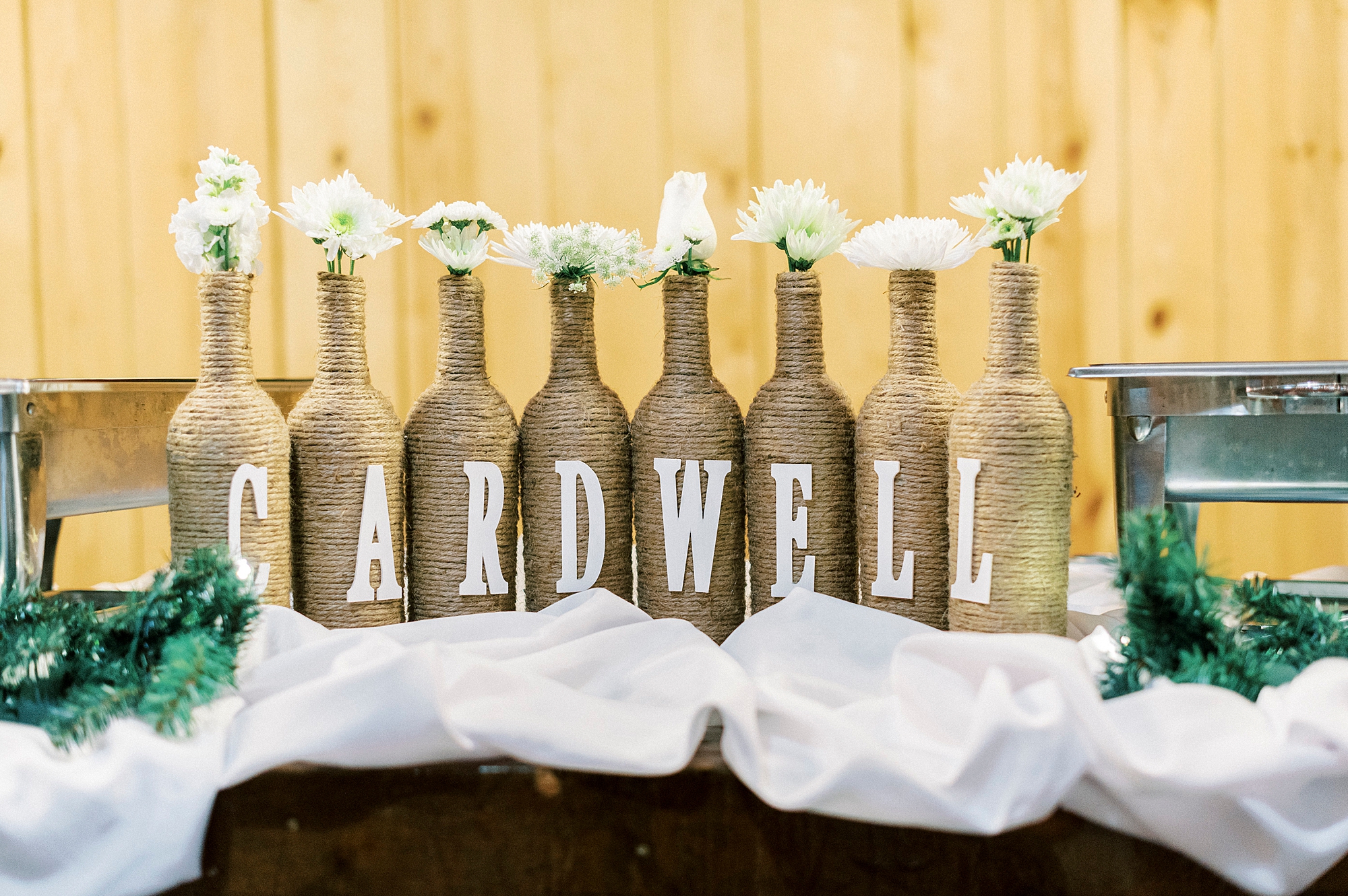 twine covered wine bottles with couple's last name on the front