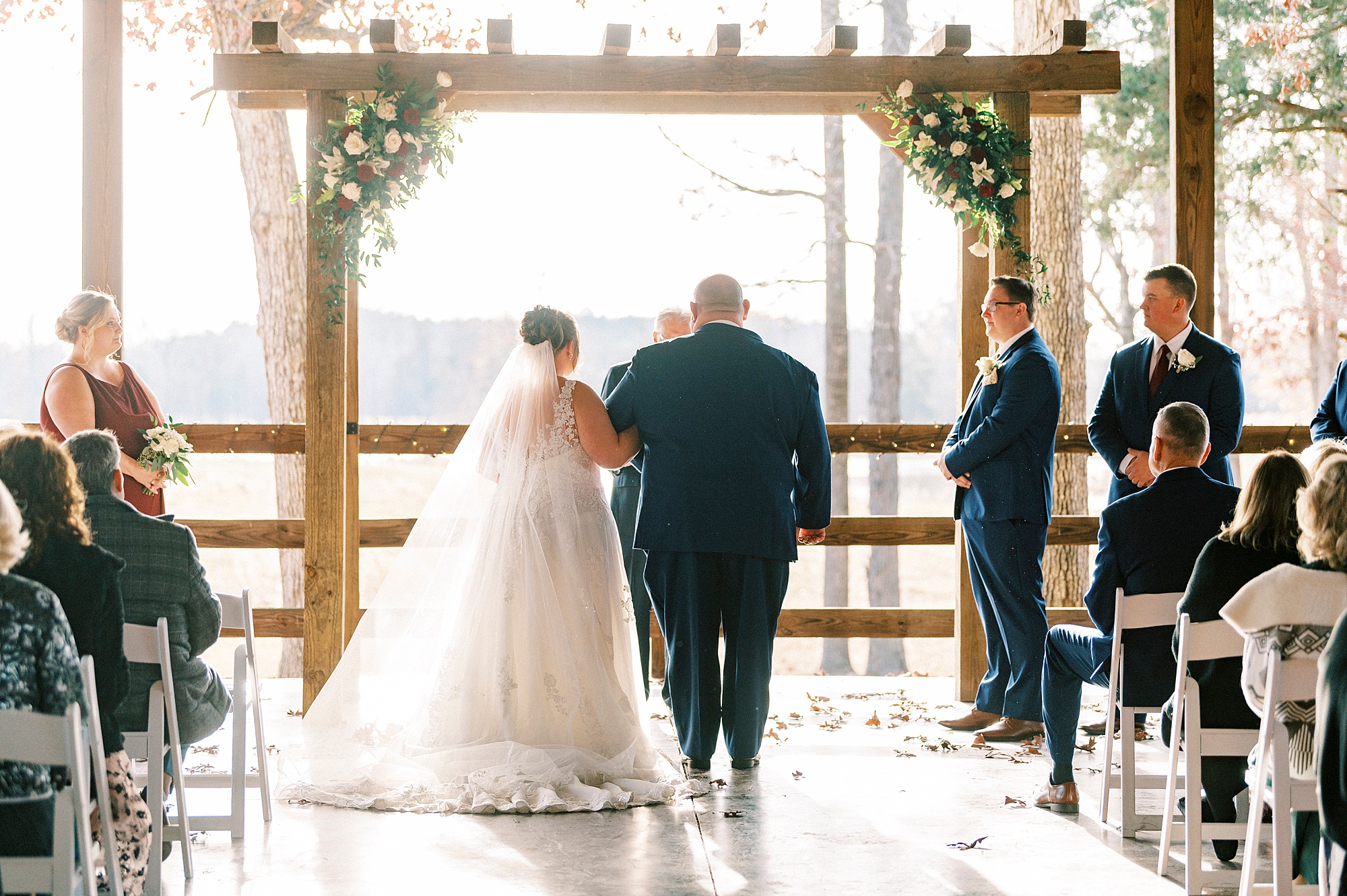 bride walks down aisle with father for wedding ceremony at the Farm at Brusharbor pavilion 