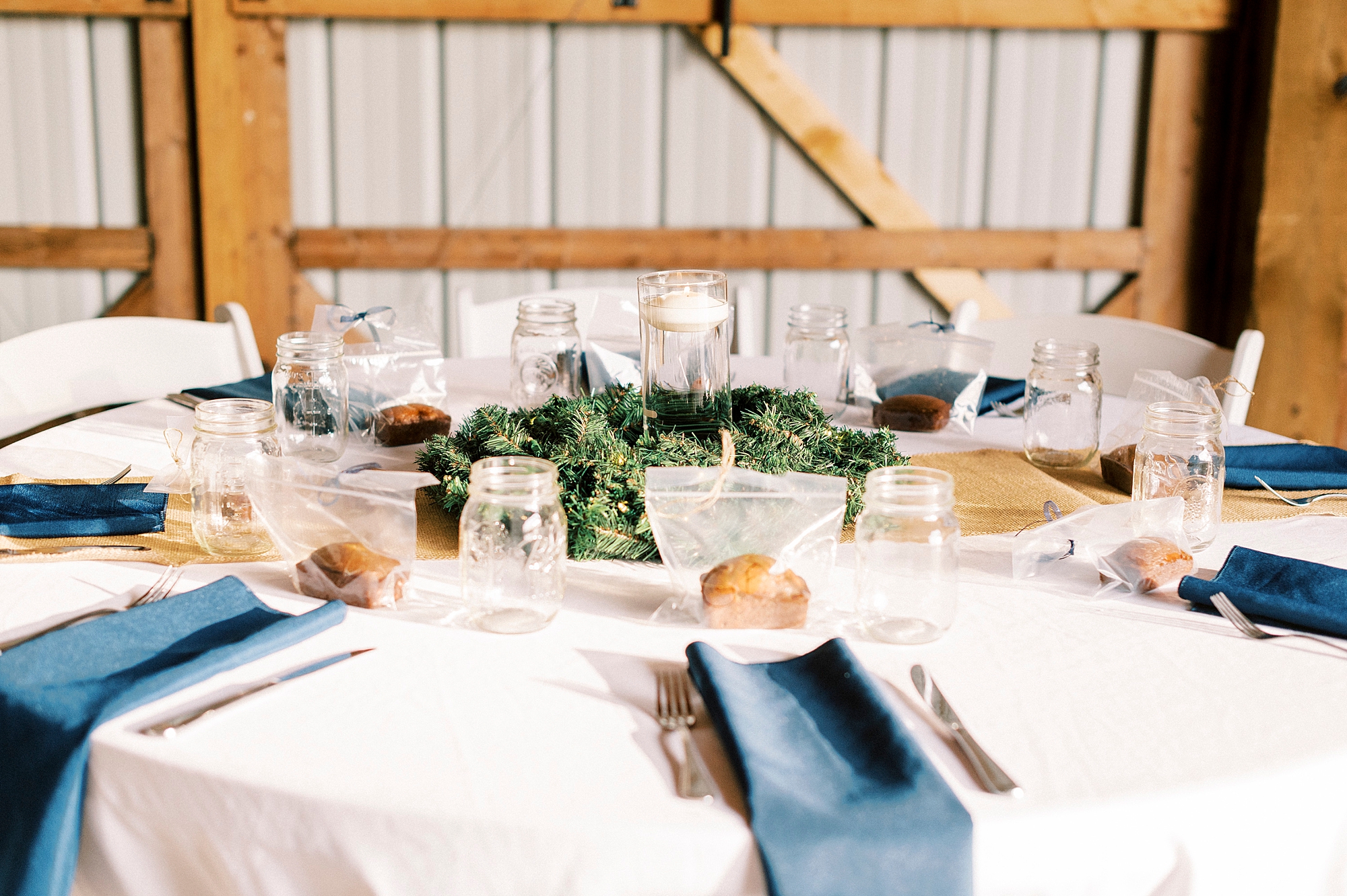 place setting with blue napkins on white table cloth at the Farm at Brusharbor
