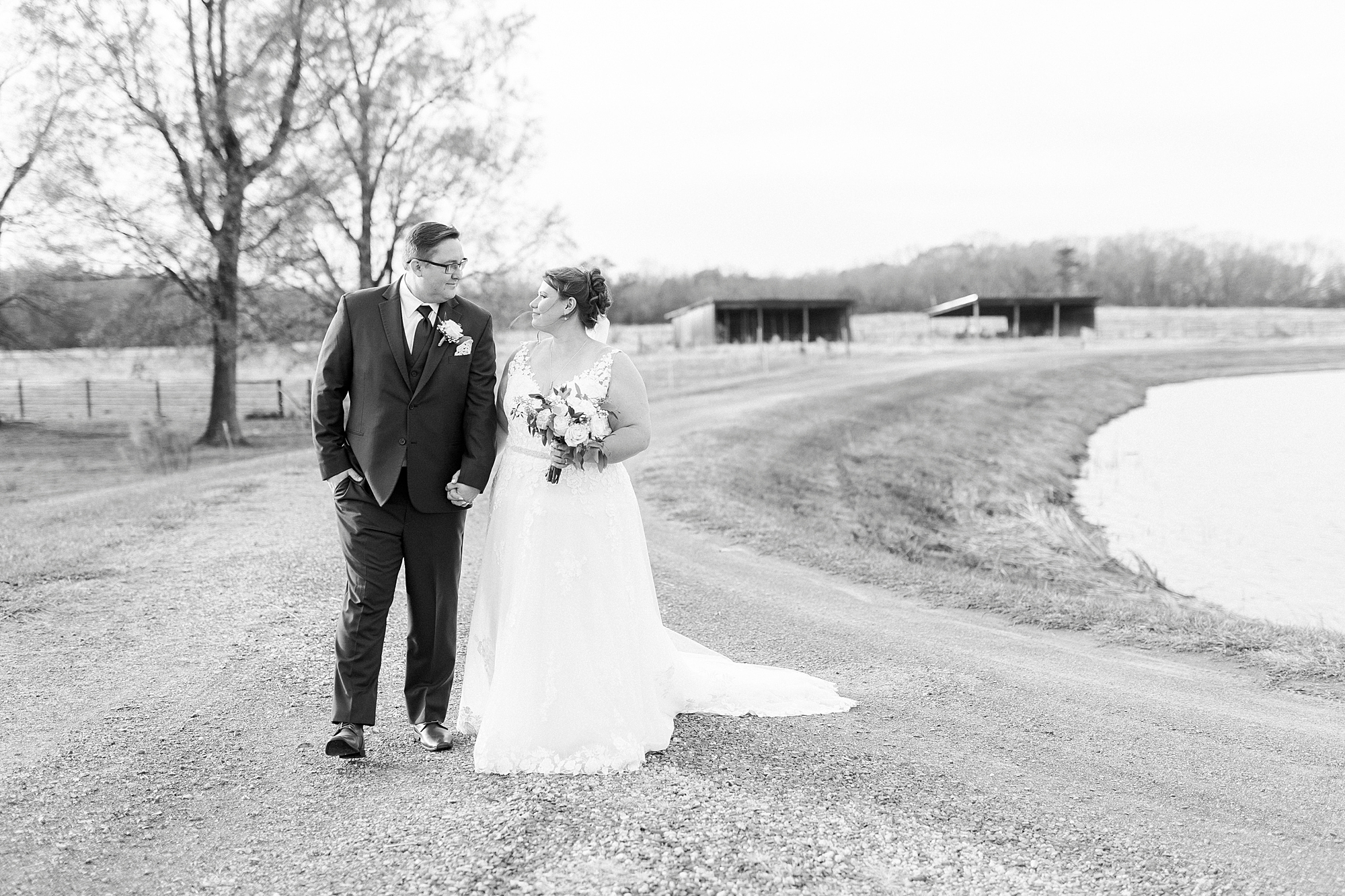 bride and groom hold hands walking on driveway of the Farm at Brusharbor
