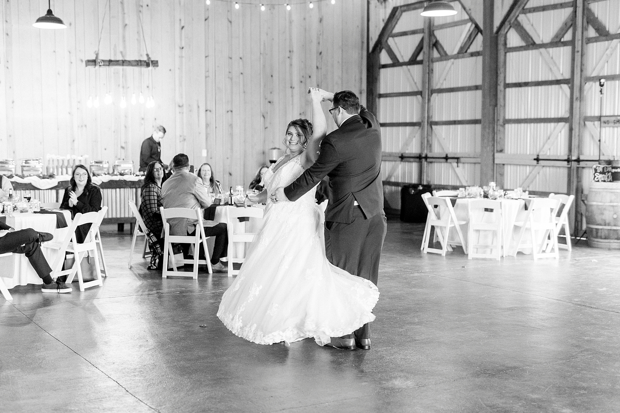 groom twirls bride during barn wedding reception at the Farm at Brusharbor