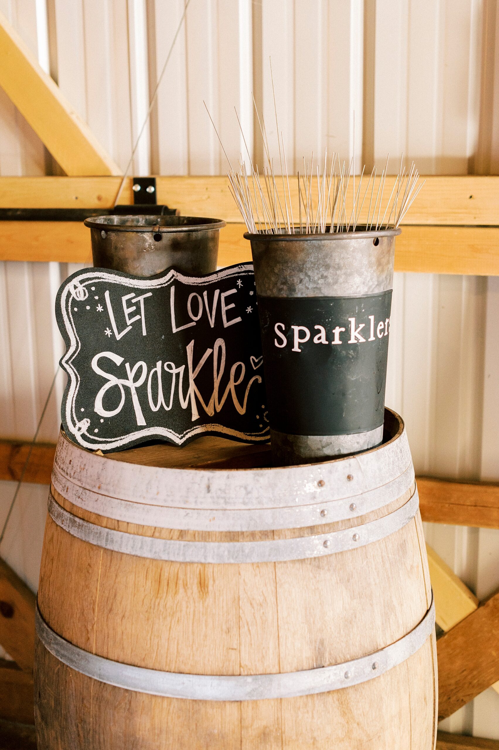 sparklers sit on wooden barrel at the Farm at Brusharbor for exit 