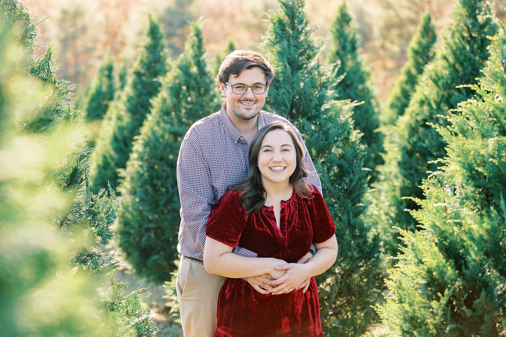 man hugs woman from behind during holiday mini session in South Carolina 