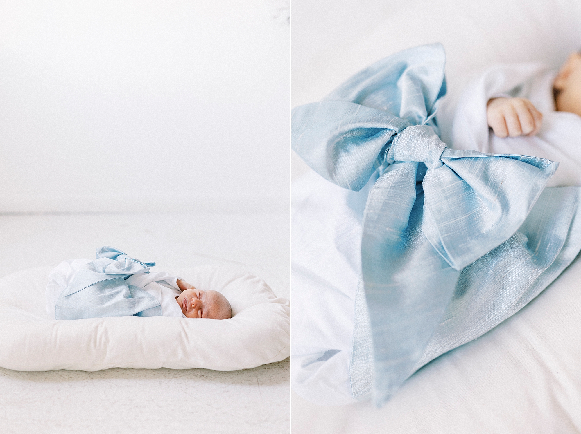 baby boy lays in blue blanket on white pillow during newborn photos