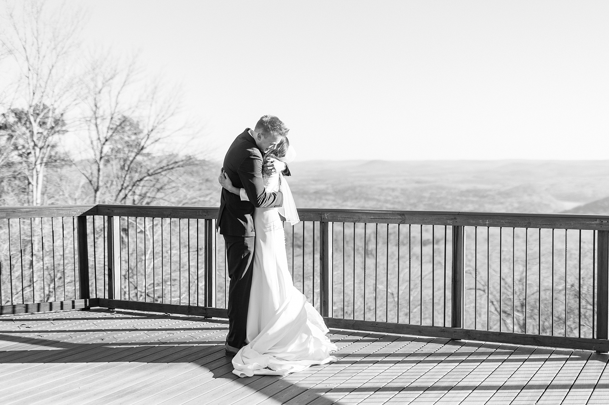 bride and groom hug on patio at Morrow Mountain