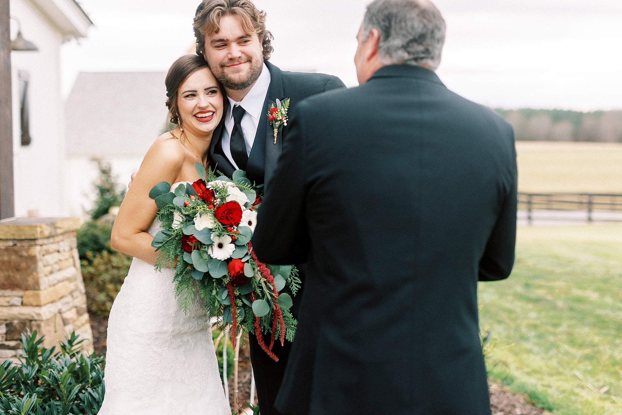father talks to bride hugging brother during wedding day