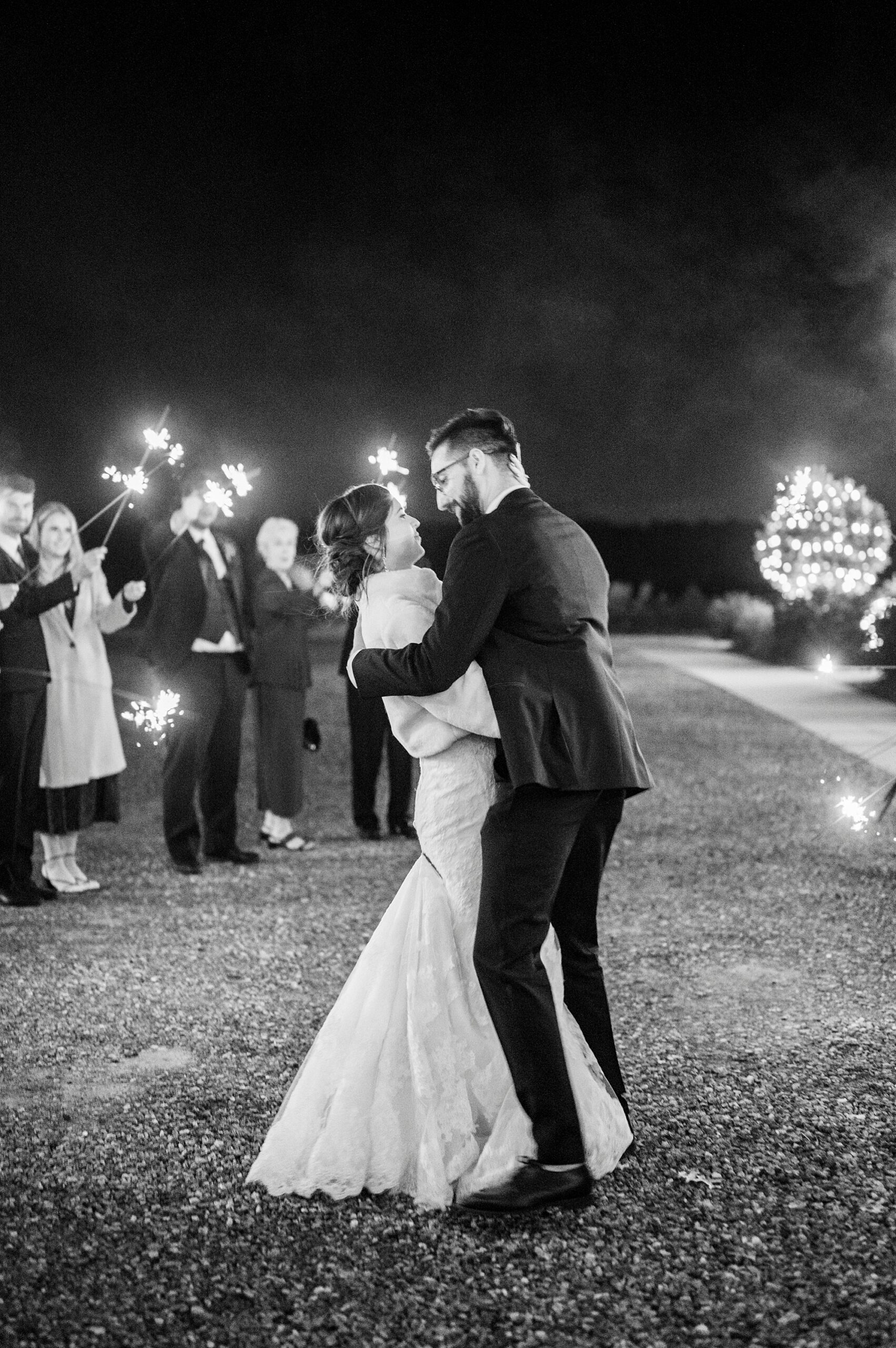 newlyweds kiss during sparkler exit leaving Statesville NC wedding reception 