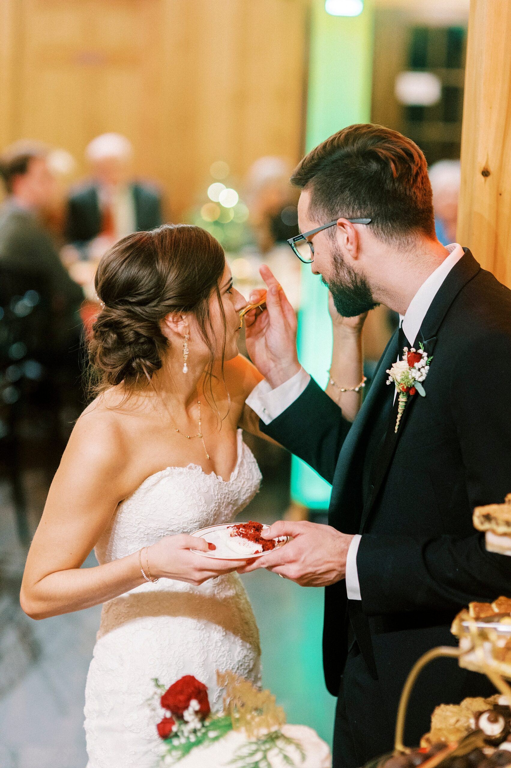 groom feeds bride cake during Statesville NC wedding reception