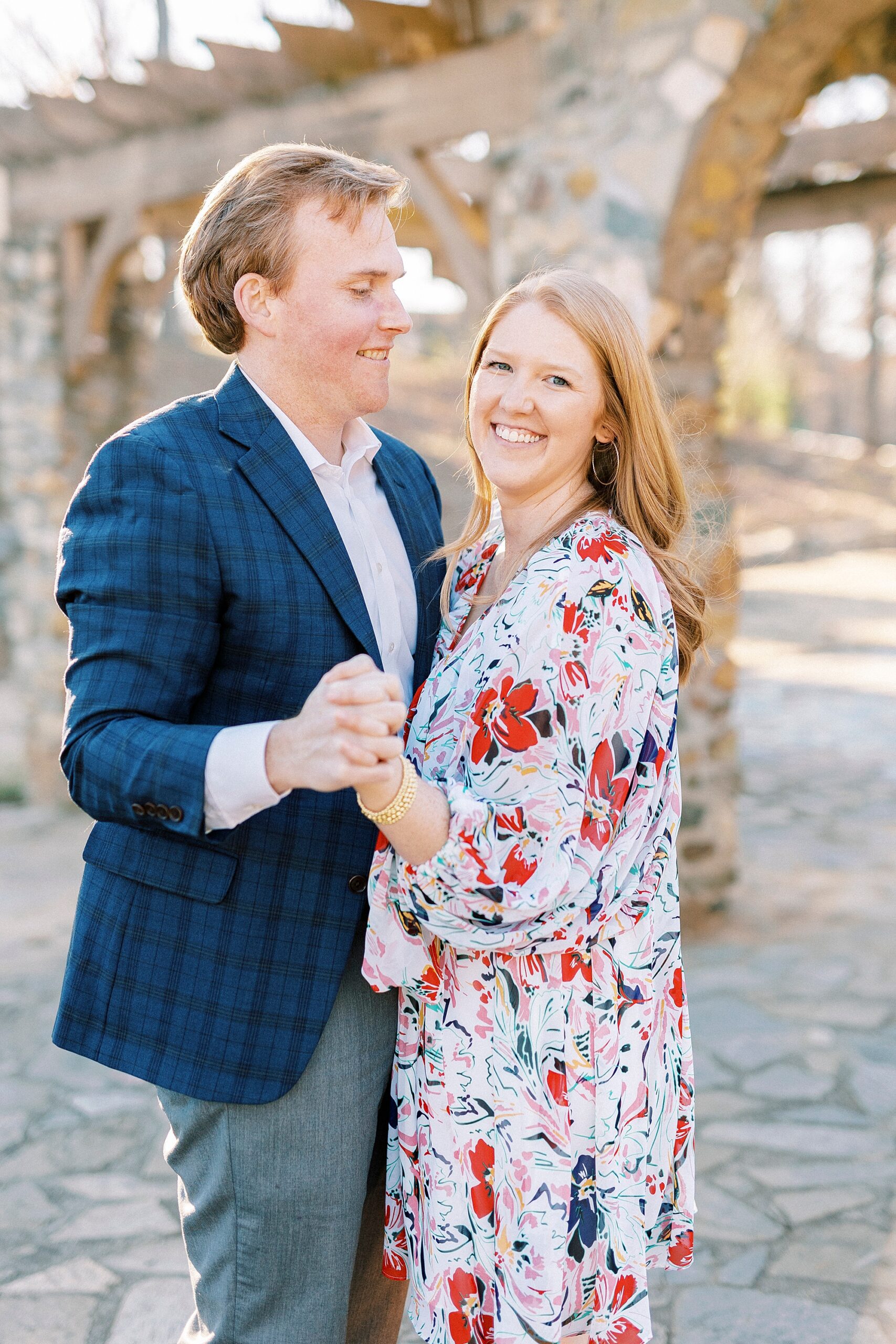 engaged couple dances during portraits at Independence Park in Charlotte NC