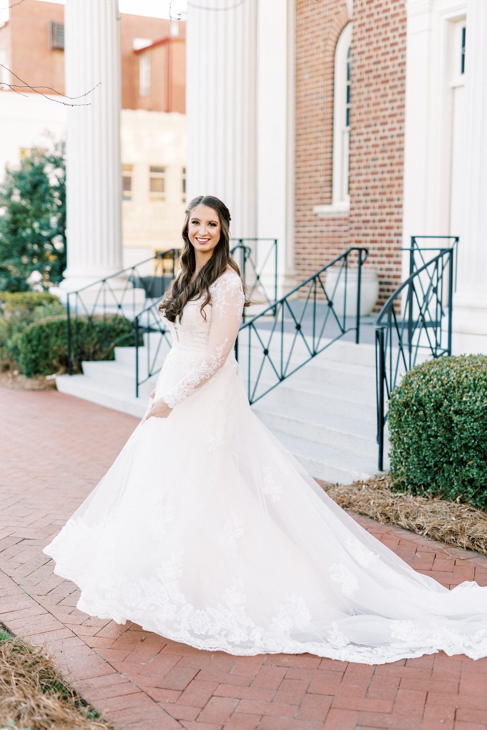 bride twirls in wedding dress during bridal portraits in Downtown Kannapolis