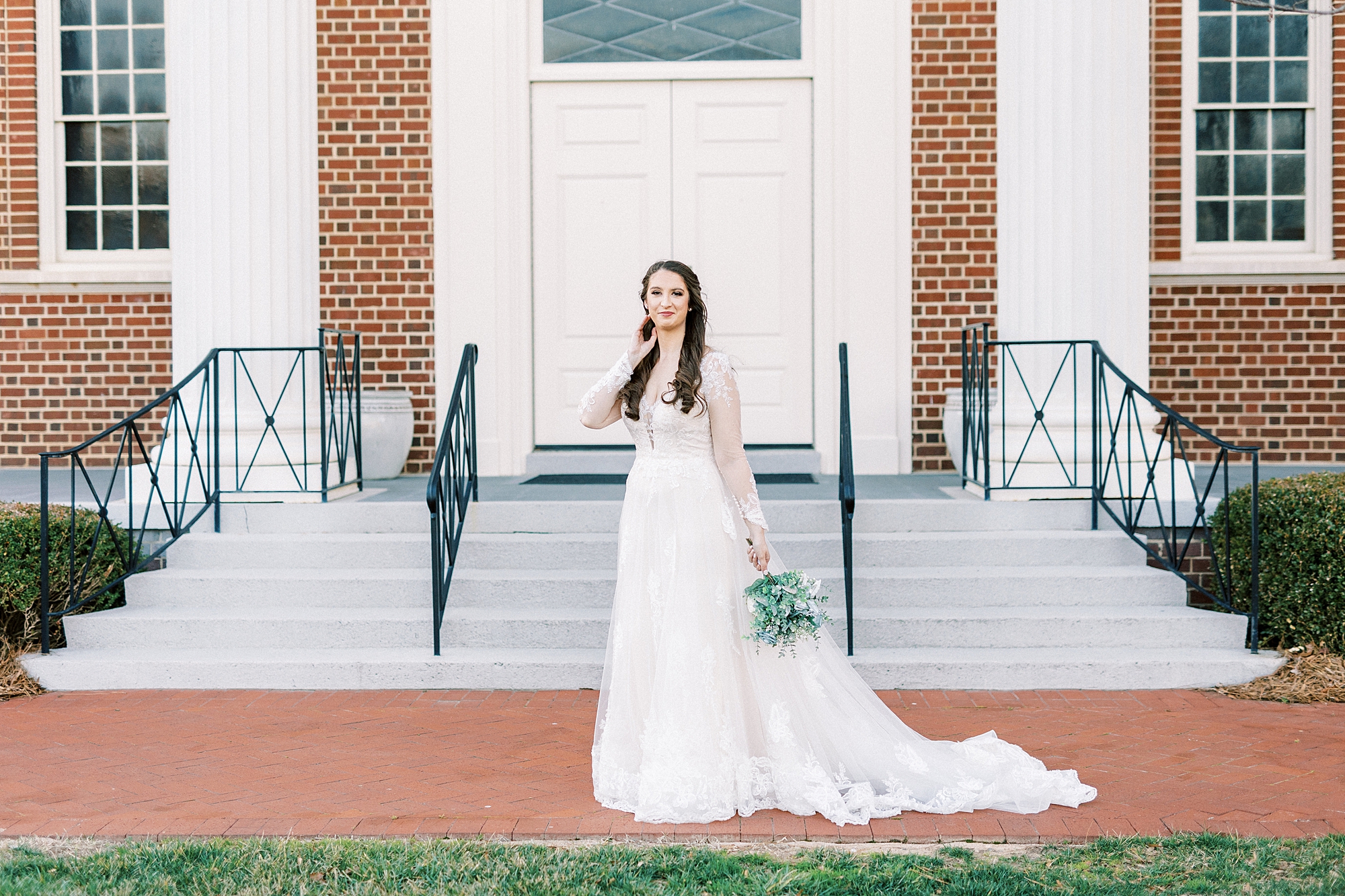 bride stands in front of church in Downtown Kannapolis