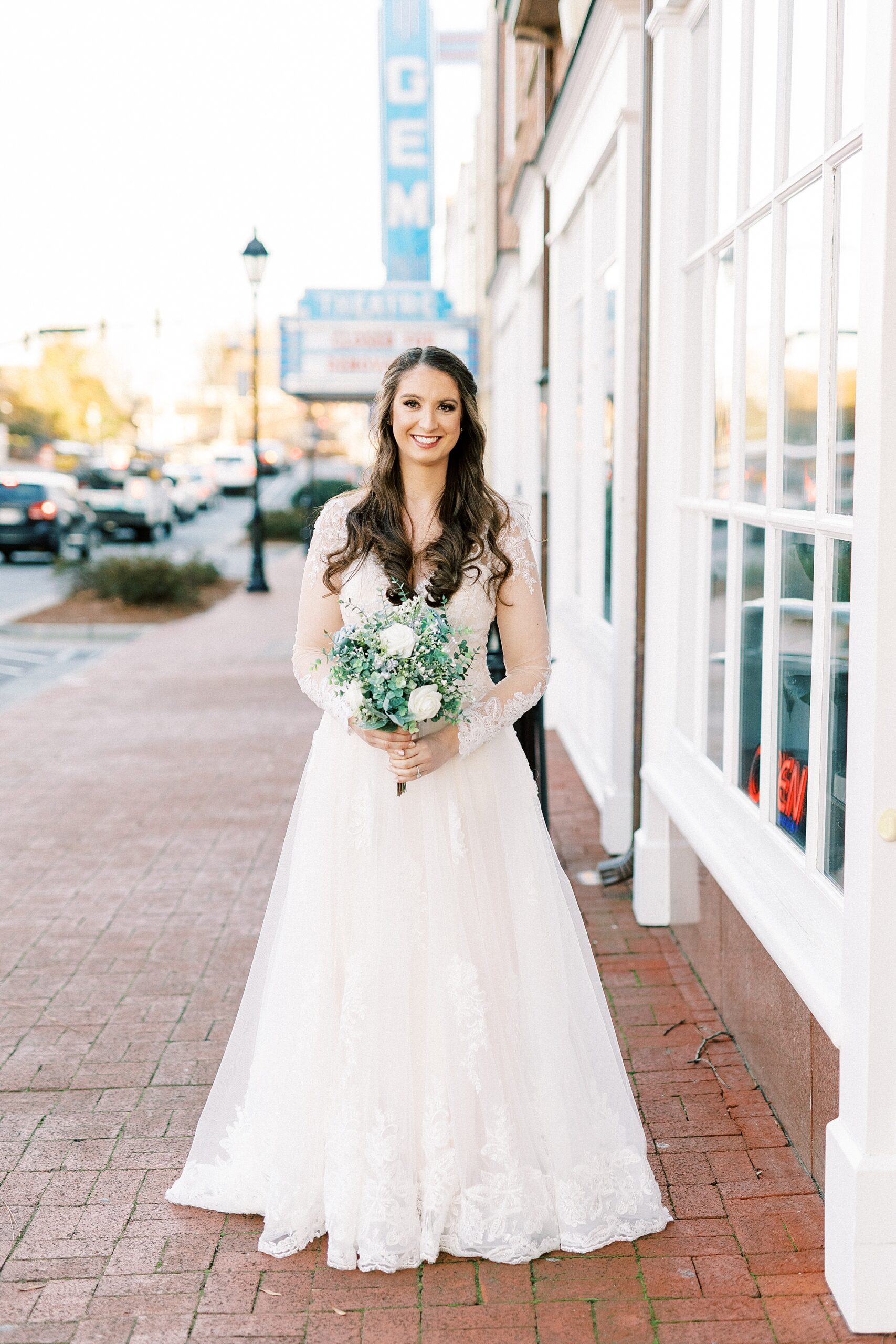 bridal portraits in Downtown Kannapolis for bride holding bouquet of white flowers