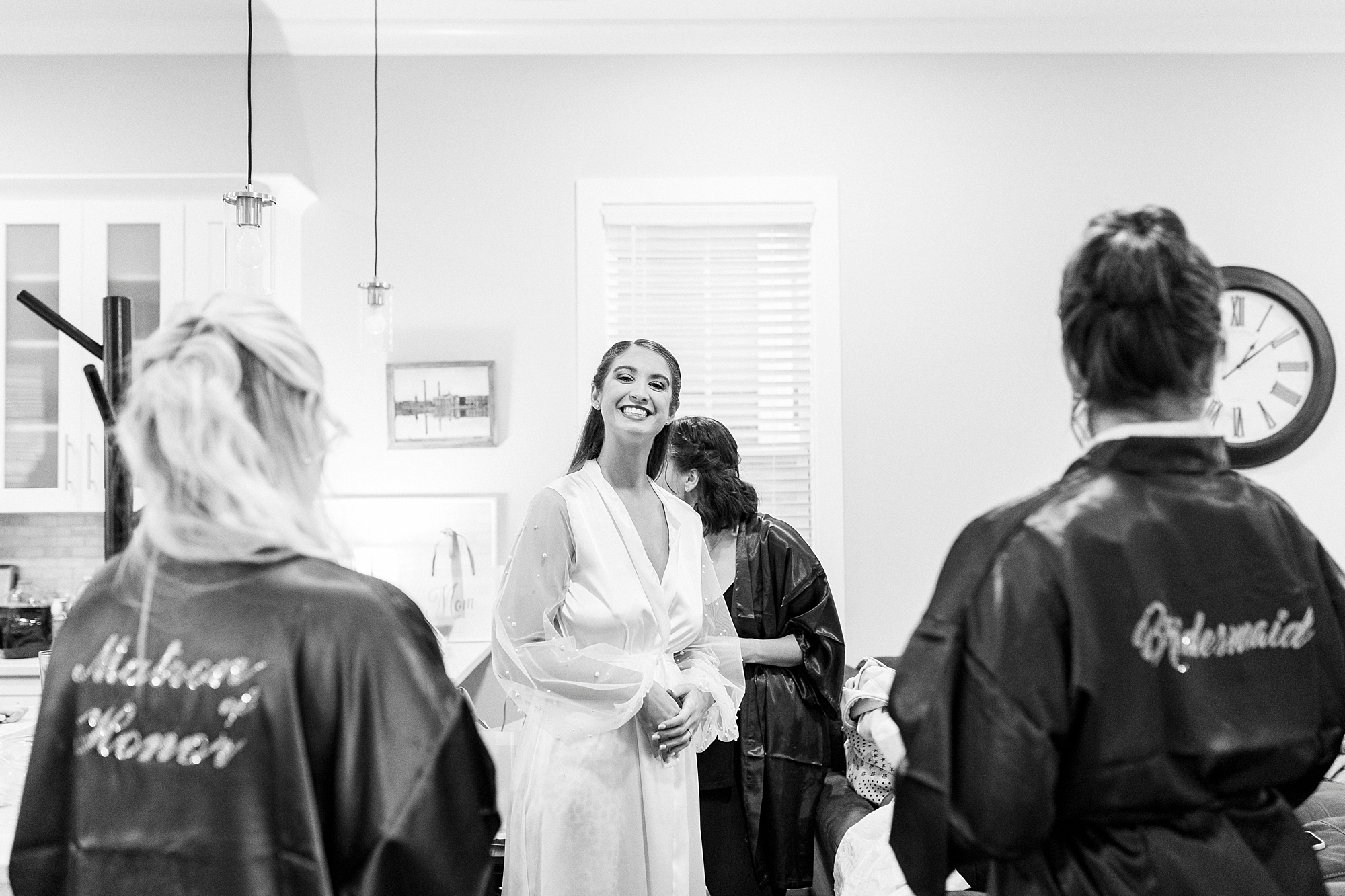 bride prepares with bridesmaids in silk robes for Downtown Kannapolis wedding