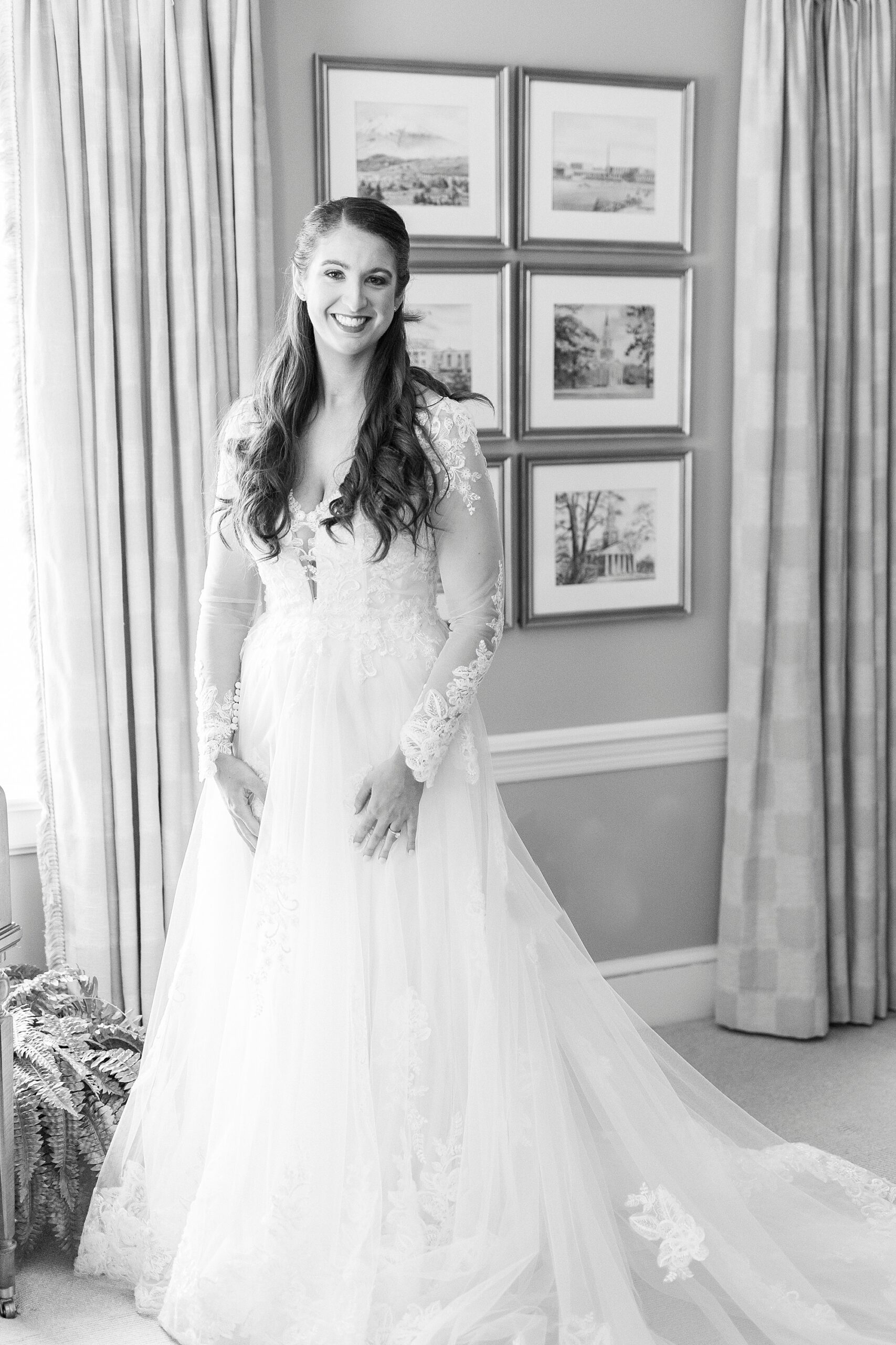 bride stands in wedding gown with lace sleeves before Downtown Kannapolis wedding