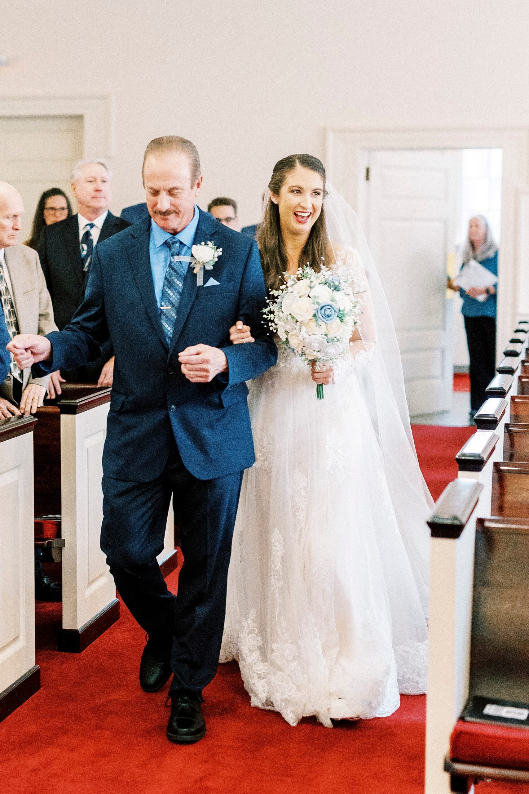 bride walks down aisle with father for ceremony inside First Baptist Church in Kannapolis NC