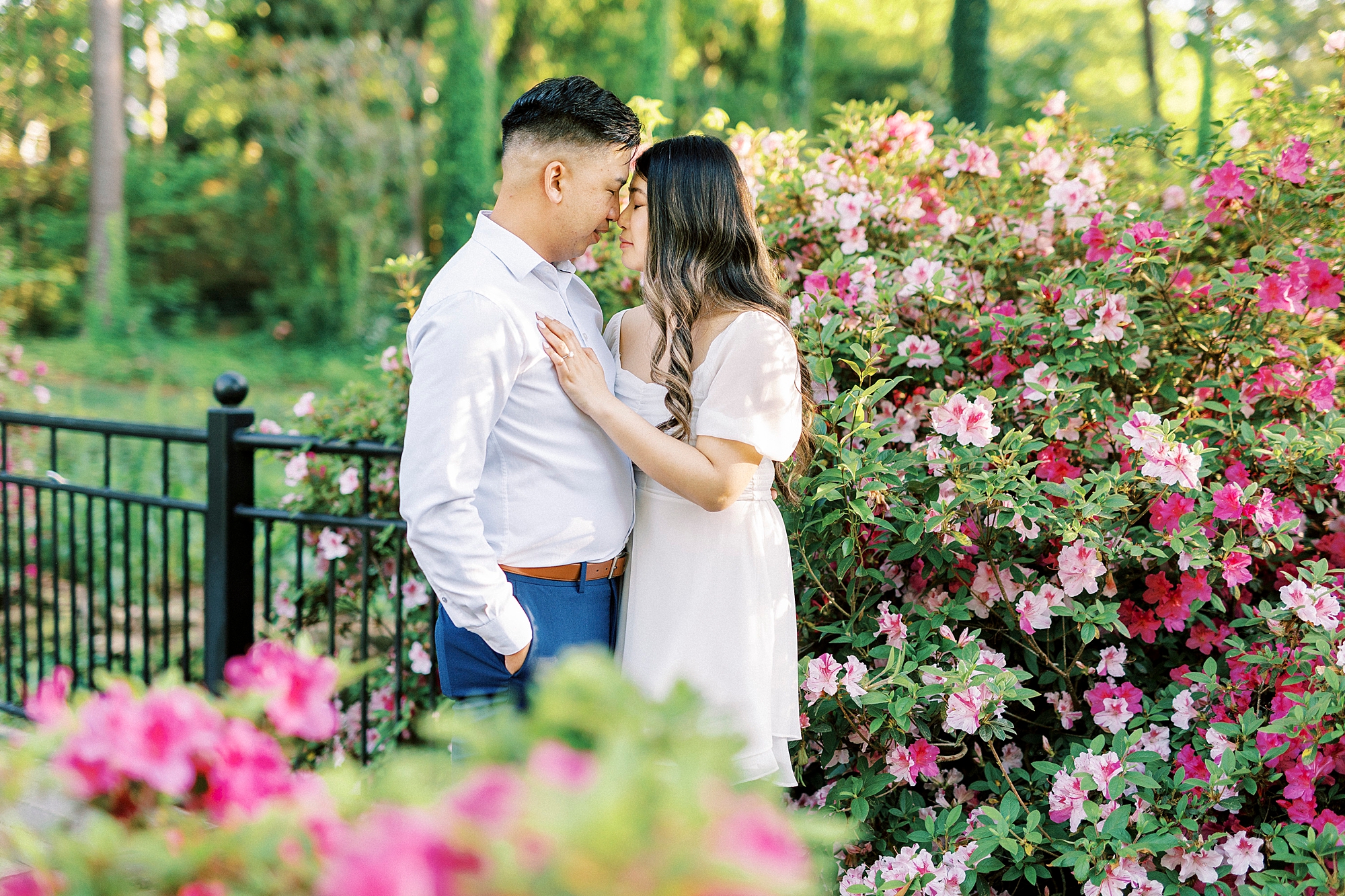 man and woman hug among pink flowers at Glencairn Garden