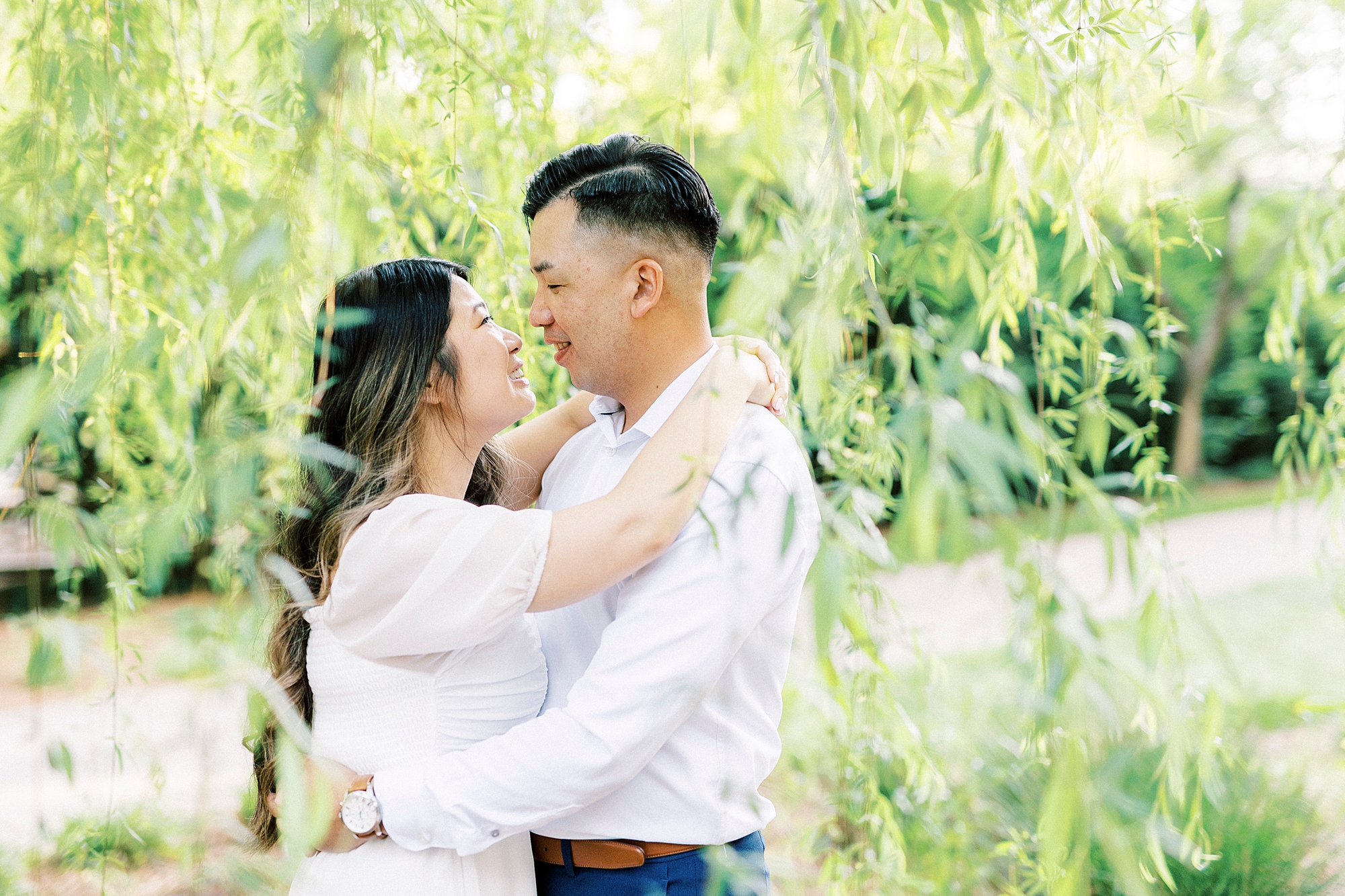 couple hugs smiling at each other in weeping willow