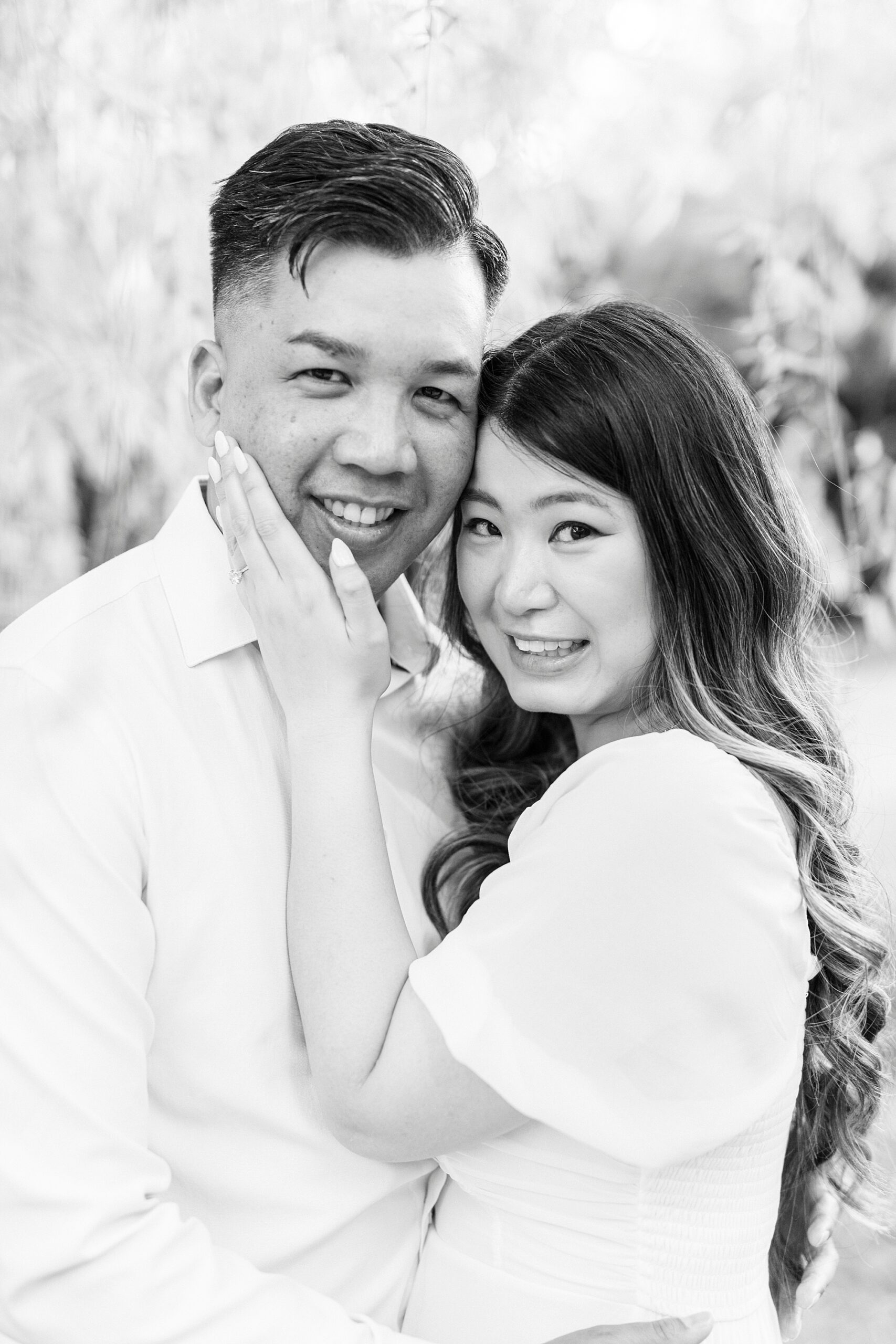 woman holds man's jaw leaning her head into his at Glencairn Garden