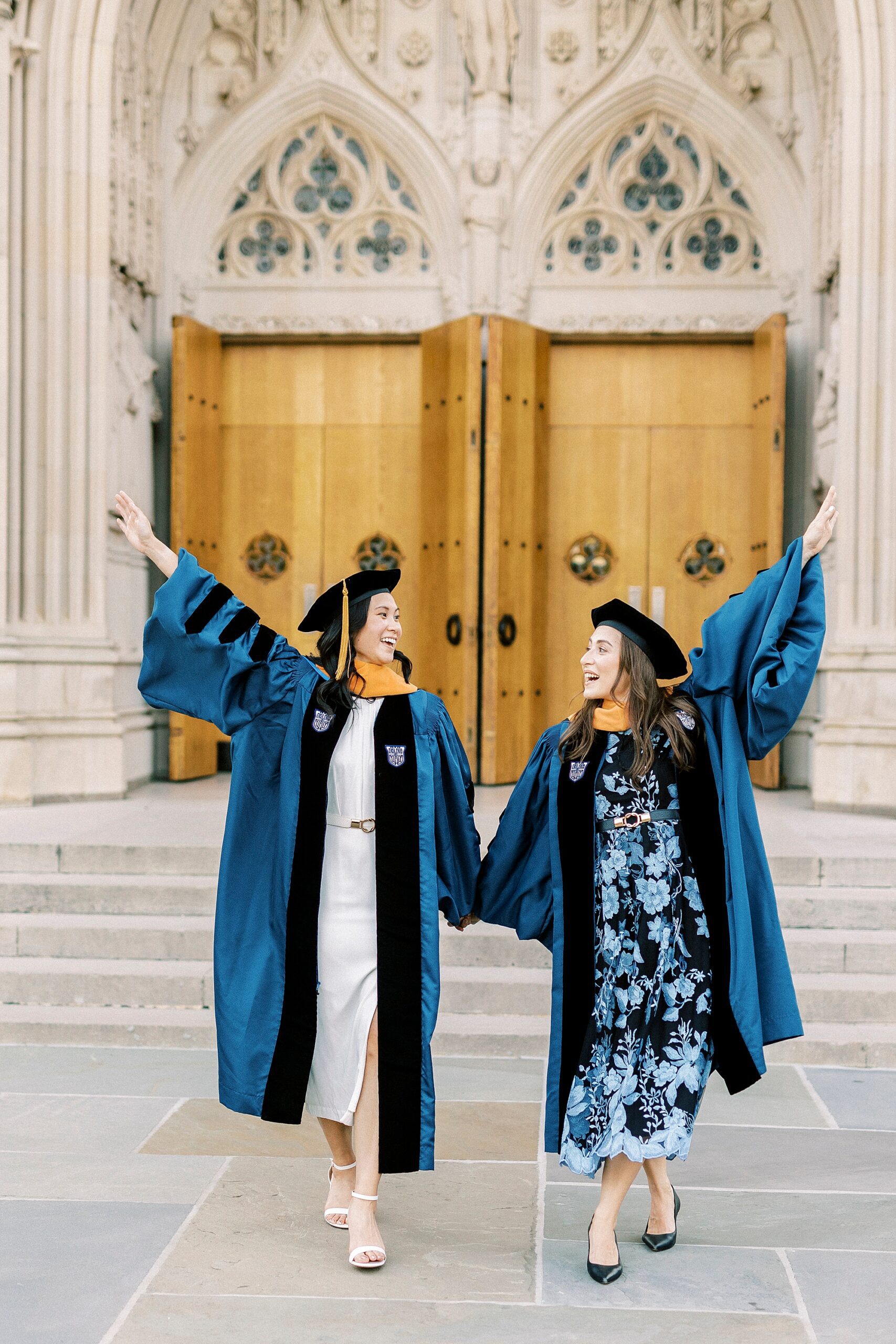 women holds hands cheering during Duke University graduation portraits