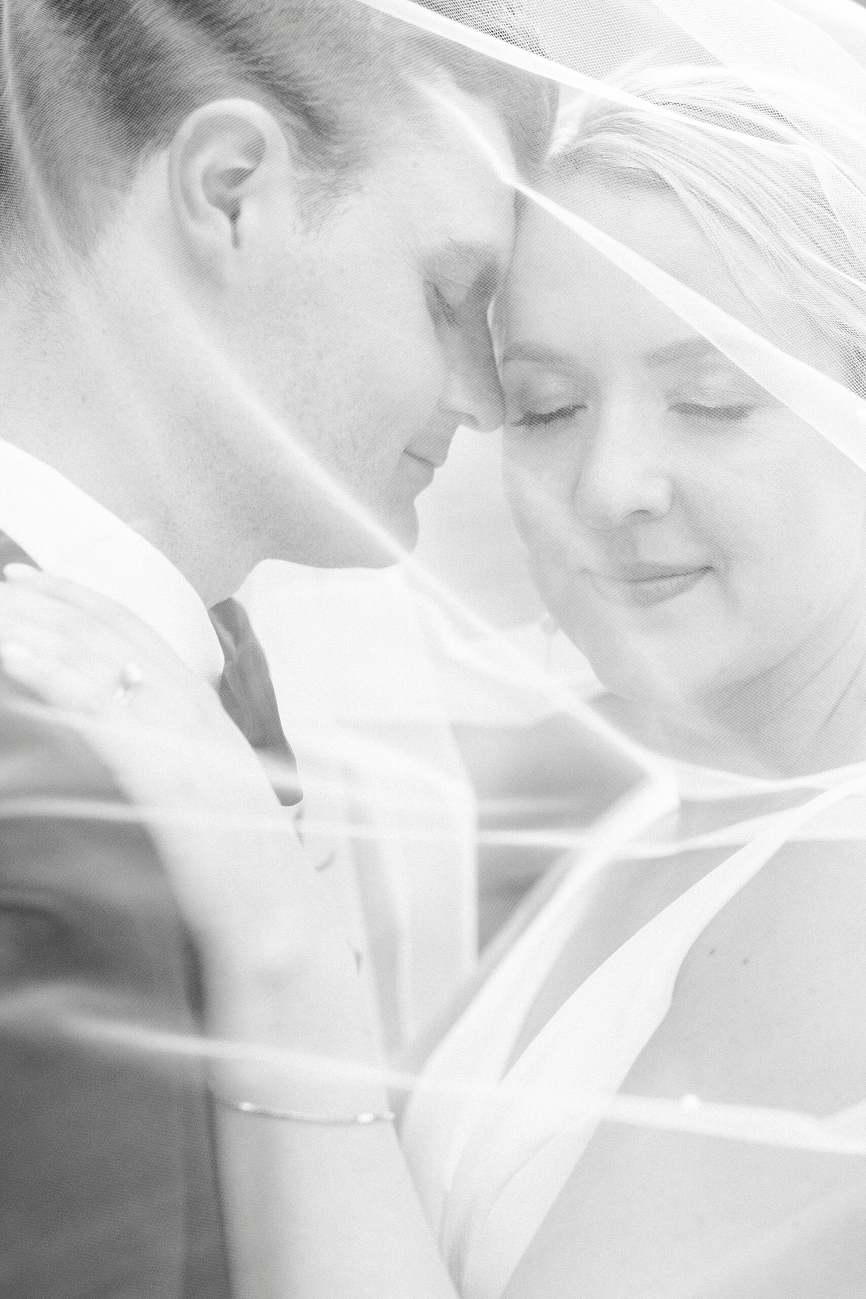 bride and groom hug under bride's veil at Myers Presbyterian Church