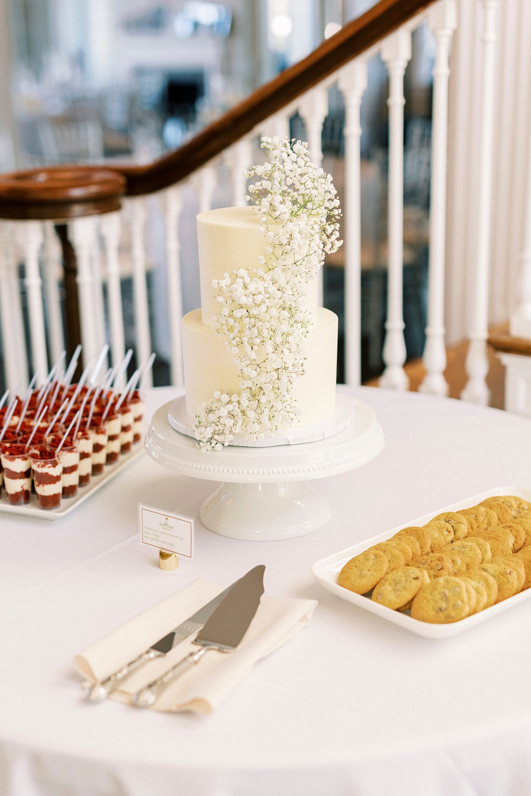 desert display with tired wedding cake with baby's breath down the side