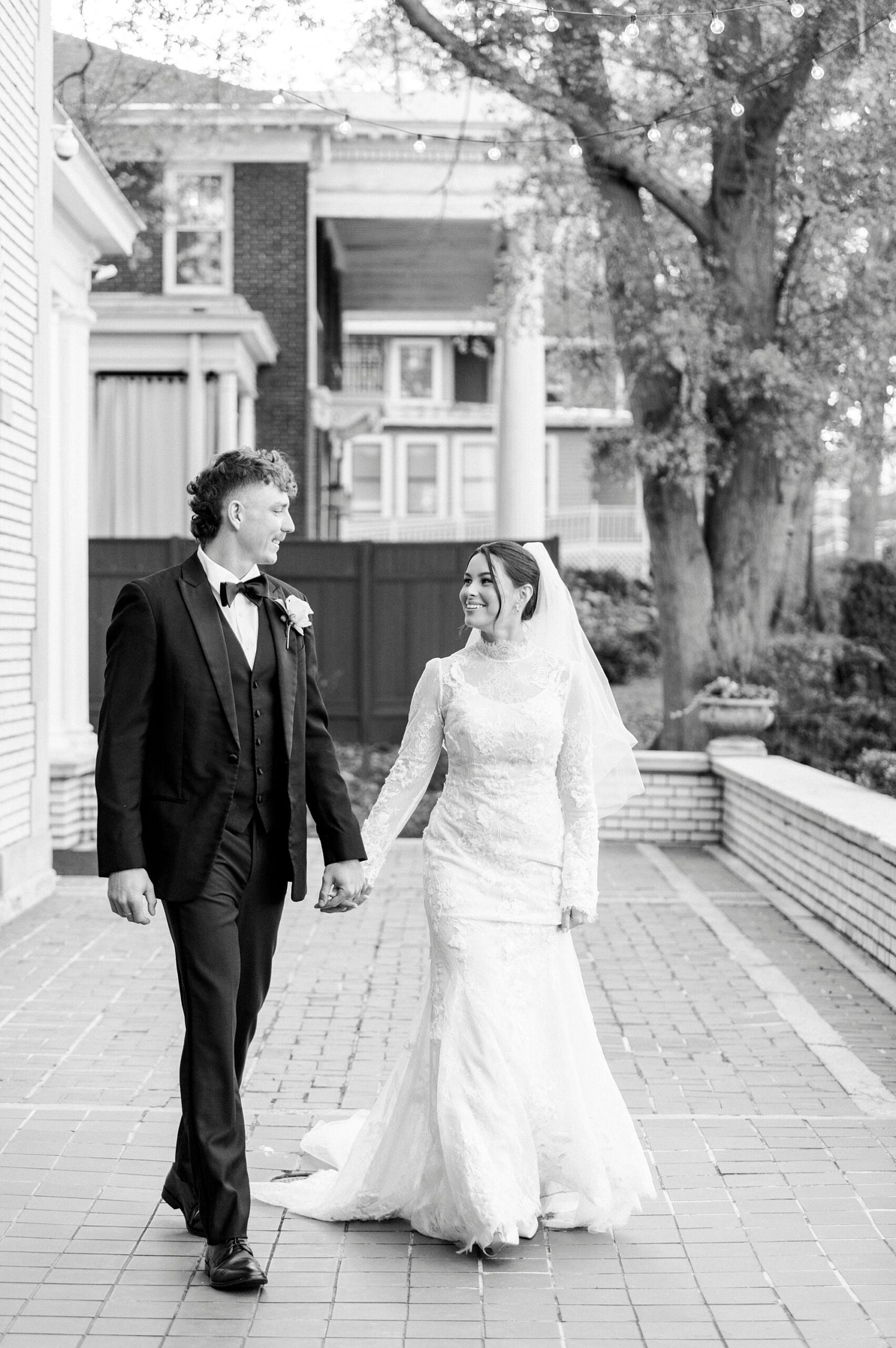 bride and groom holds hands walking on patio at Separk Mansion