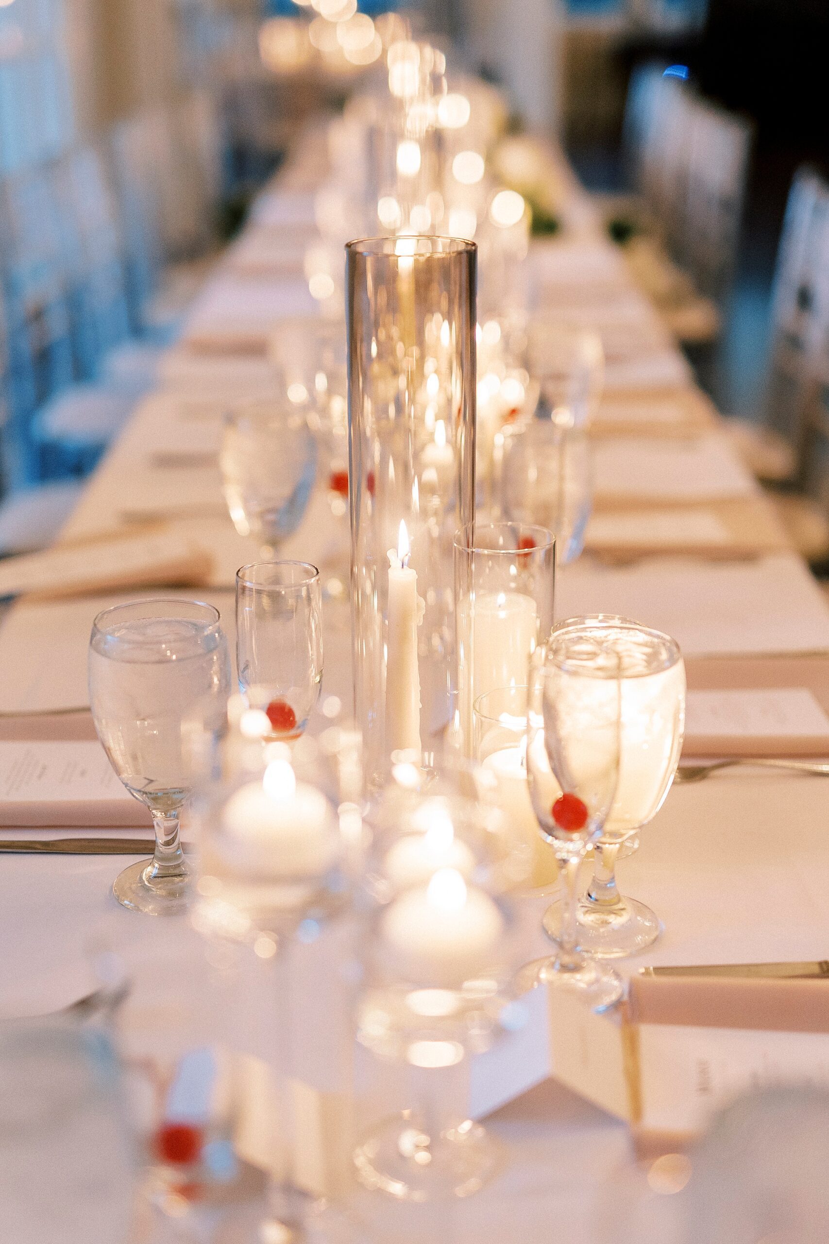 floating candles and glasses with cherries at the bottom on table at Separk Mansion