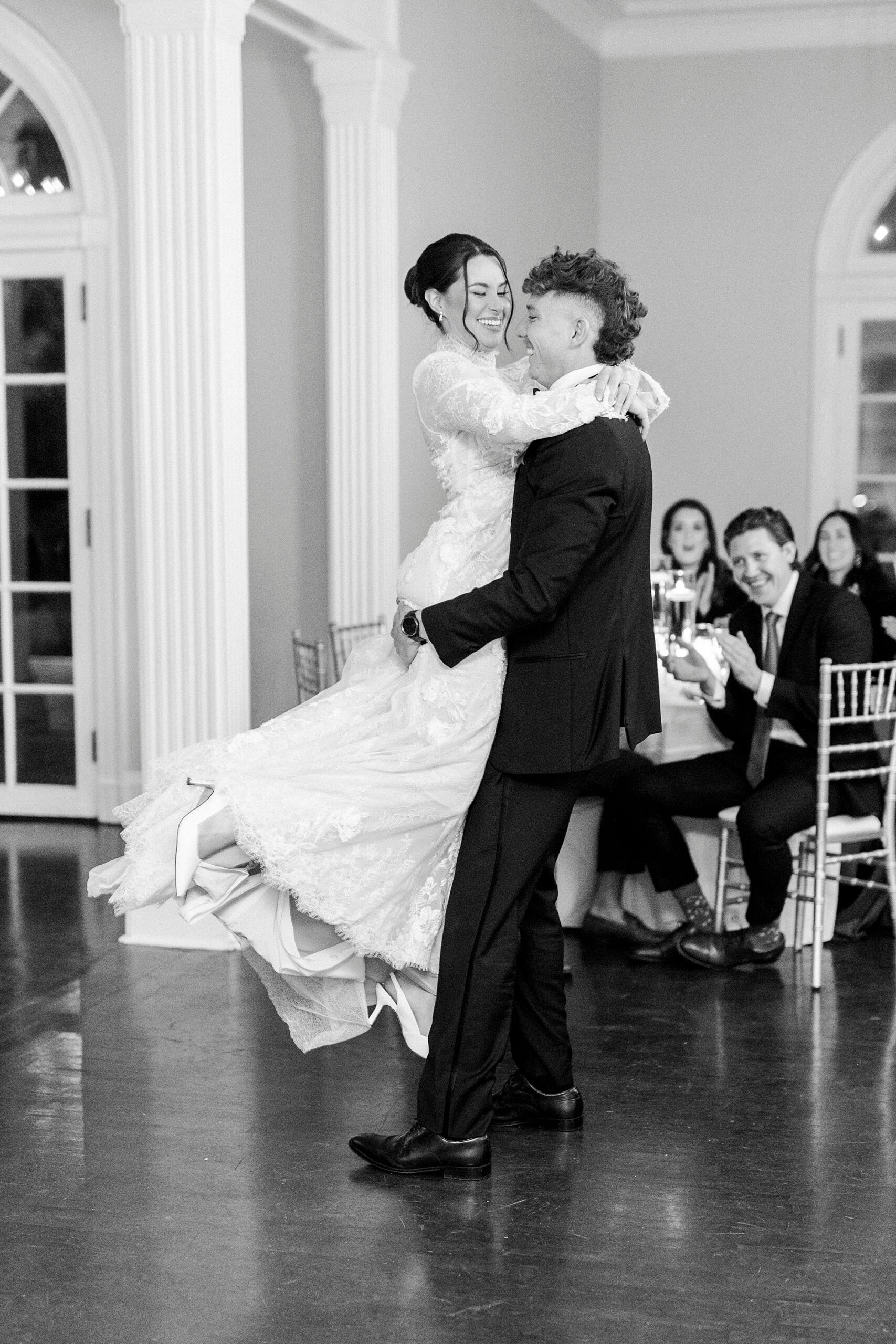 groom lifts up bride twirling her at reception in Charlotte NC